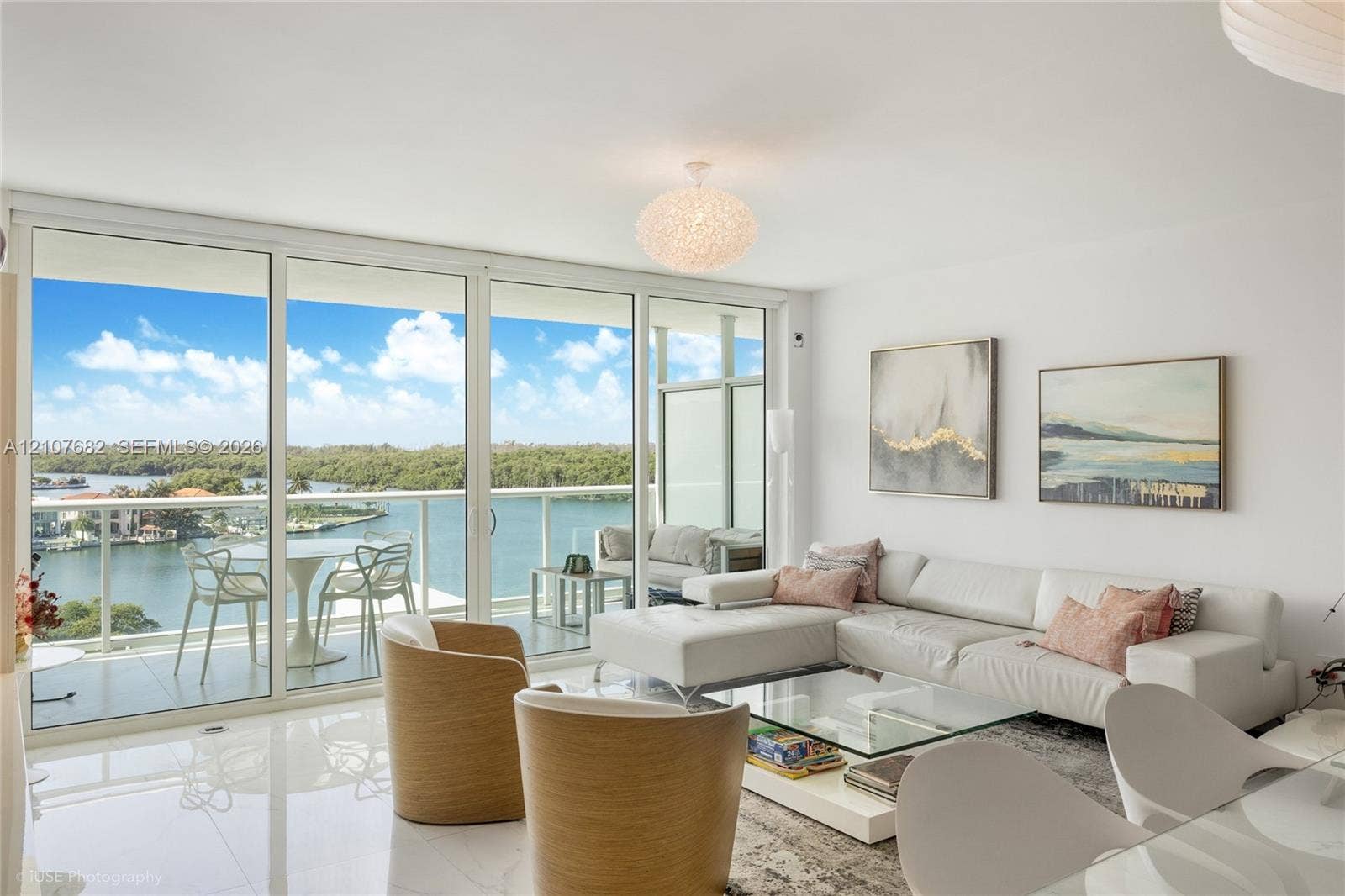400 Sunny Isles Boulevard, #704, Sunny Isles Beach, Sunny Isles Beach, FL 33160 Floor-to-ceiling glass sliding doors, private balcony with metal railing, polished stone-finish flooring, and pendant lighting