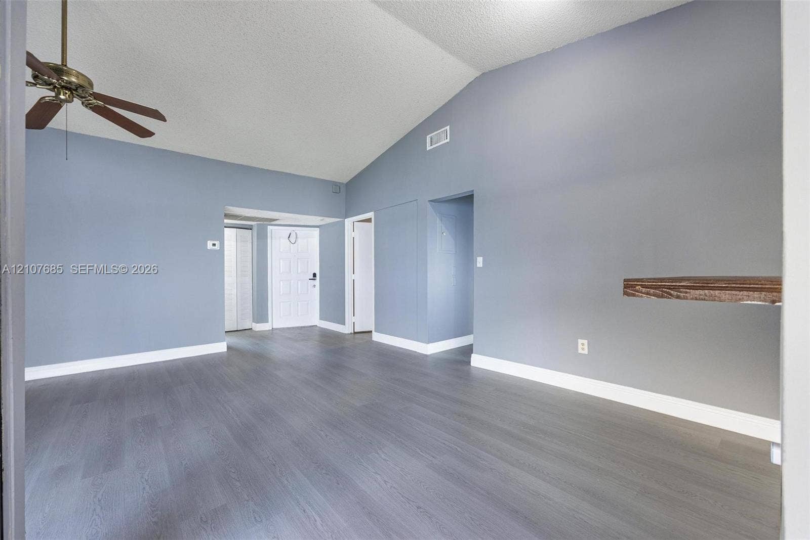 1460 Jefferson Drive, #1460L, Homestead, FL 33034 Vaulted ceilings, wood-finish flooring, and a ceiling fan with integrated lighting