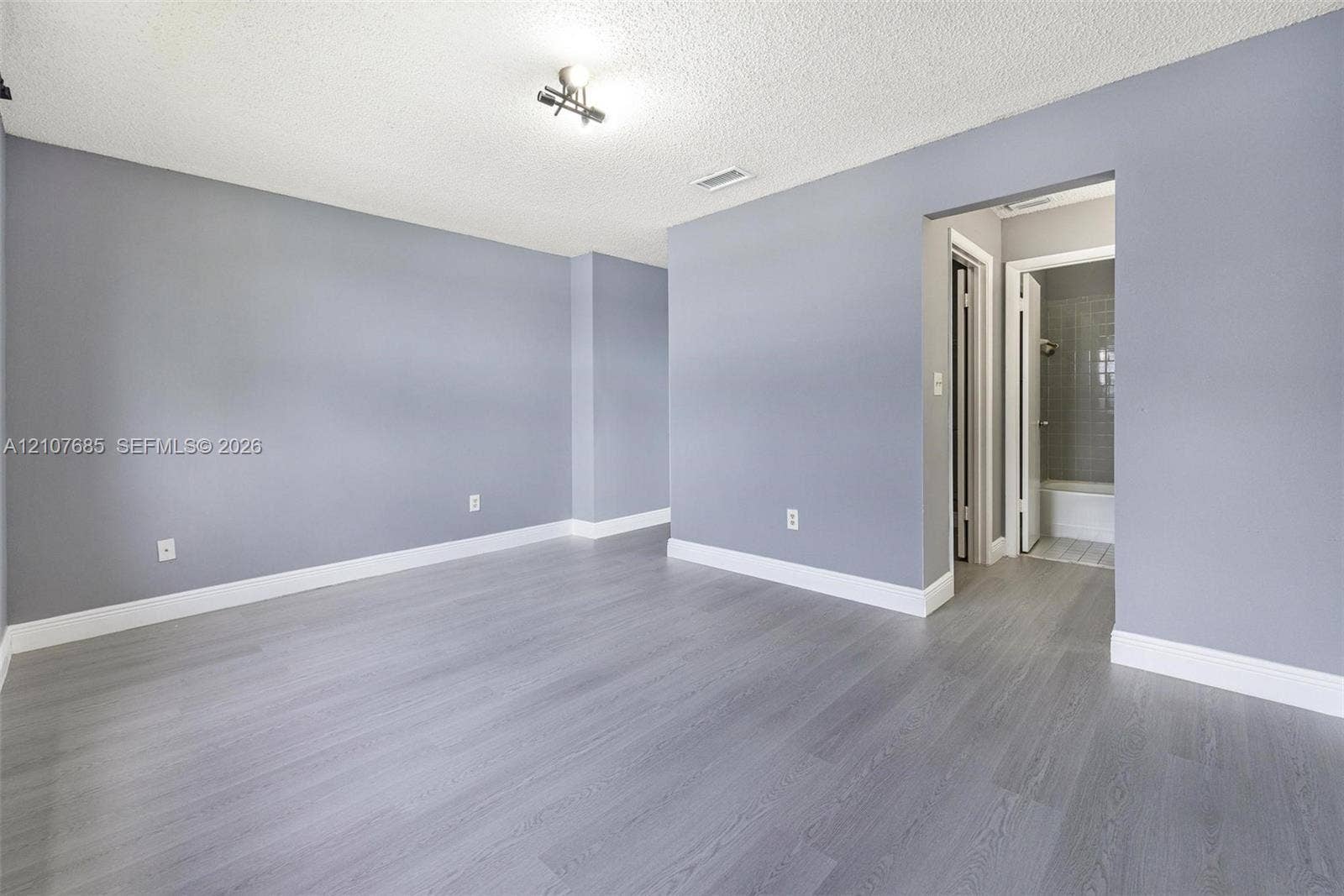 1460 Jefferson Drive, #1460L, Homestead, FL 33034 Room featuring wood-finish flooring, neutral wall tones, and recessed ceiling lighting