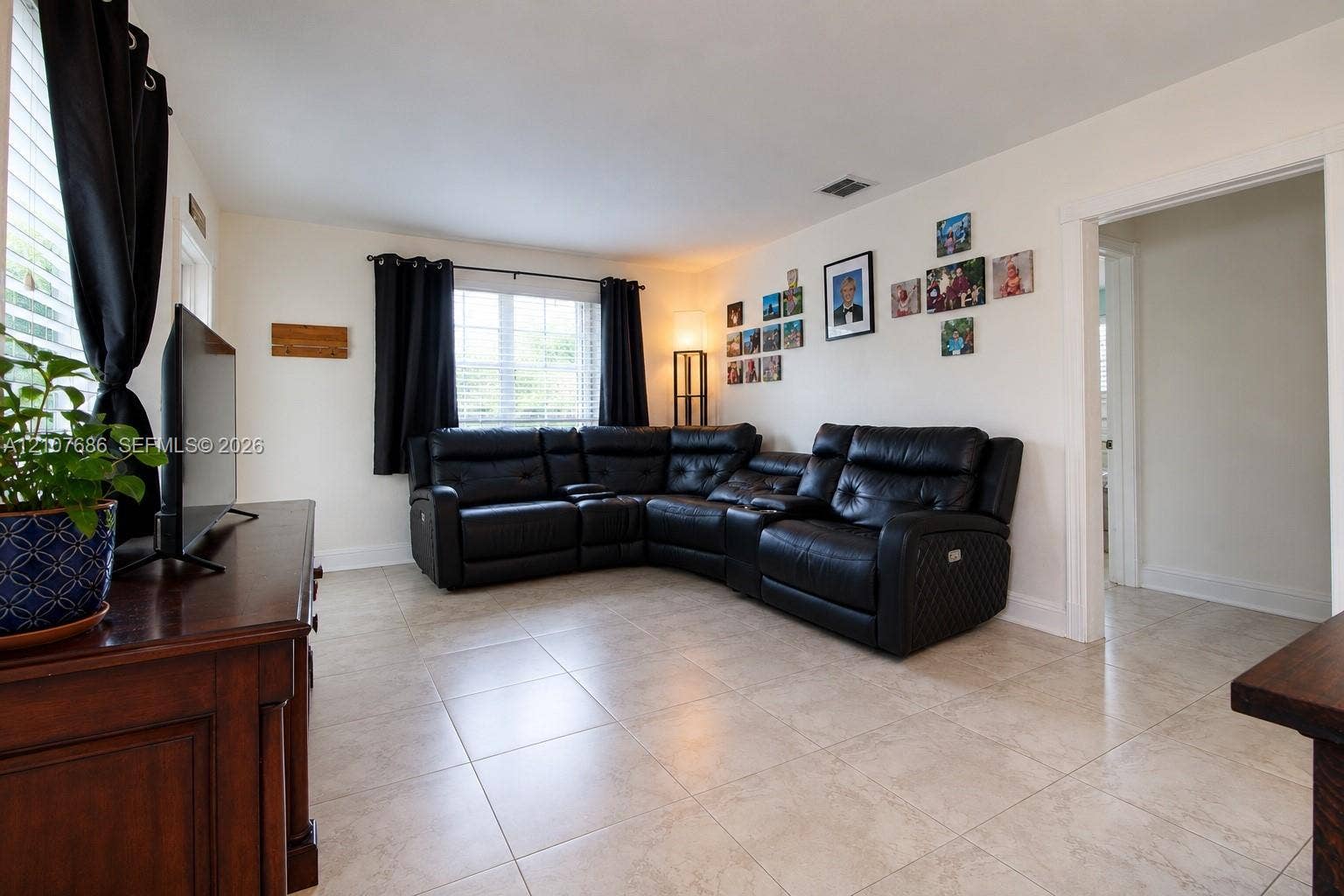 9760 Jamaica Drive, Cutler Bay, FL 33189 Living area featuring neutral stone-finish tile flooring, recessed lighting, and expansive windows