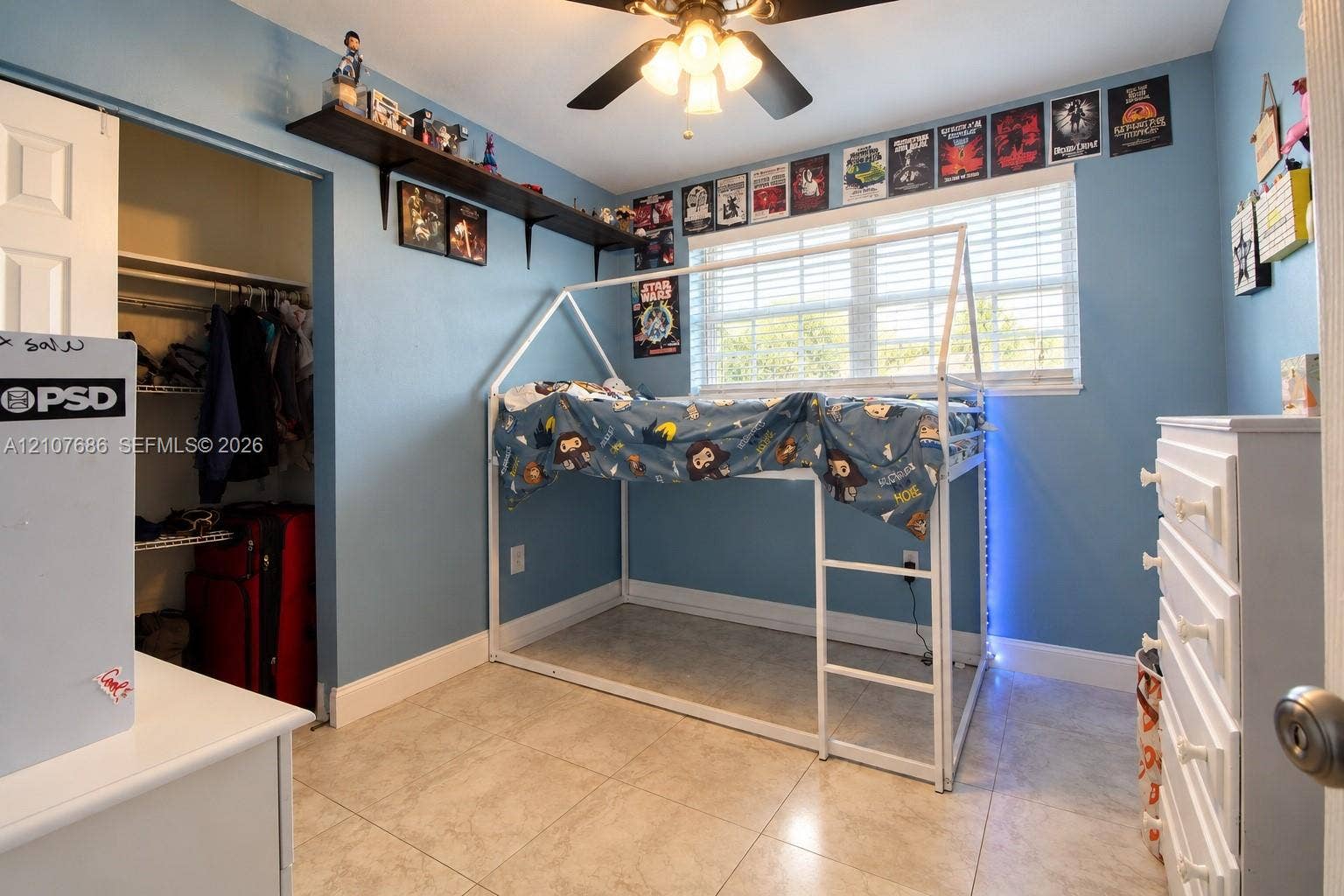 9760 Jamaica Drive, Cutler Bay, FL 33189 Room featuring tile flooring, ceiling fan with integrated light fixture, horizontal window blinds, and a built-in wall shelf