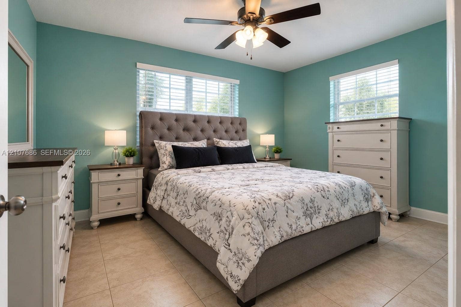 9760 Jamaica Drive, Cutler Bay, FL 33189 Neutral-toned tile flooring, dual windows with horizontal blinds, and a central ceiling fan with integrated lighting