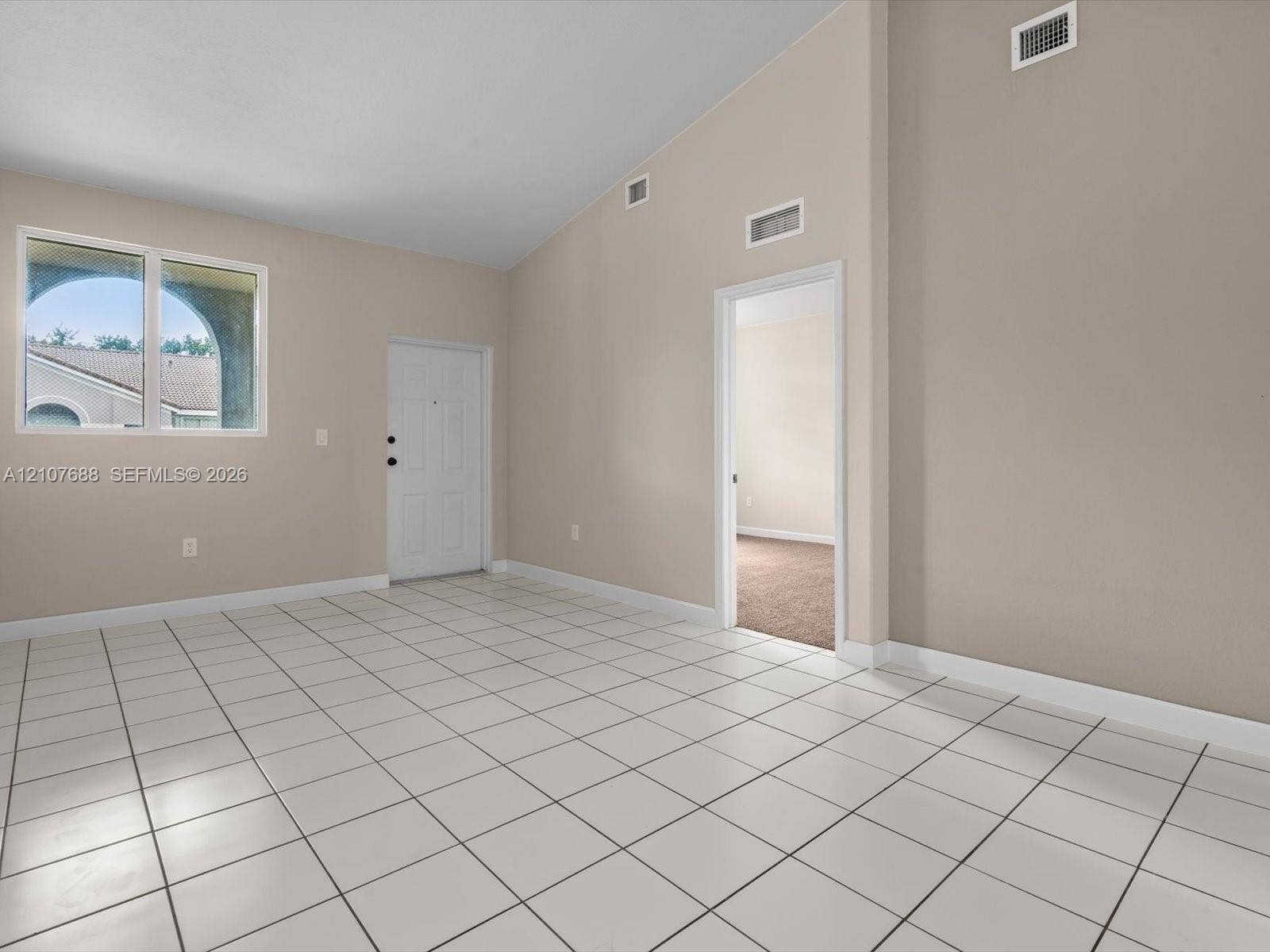 1677 SE 27th Court, #202, Homestead, FL 33035 Vaulted ceilings, neutral wall tones, ceramic tile flooring, and oversized windows