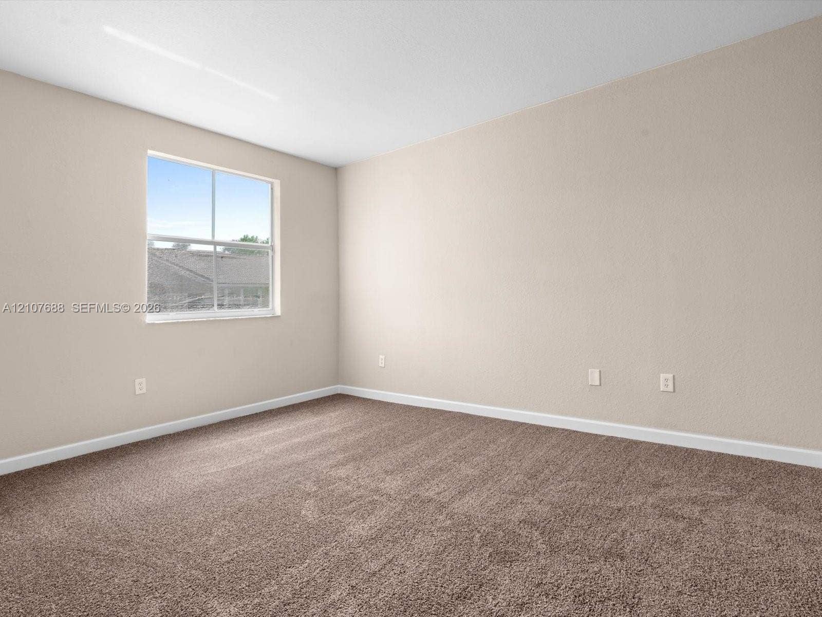1677 SE 27th Court, #202, Homestead, FL 33035 Neutral-toned walls, wall-to-wall carpeting, and a single-hung window