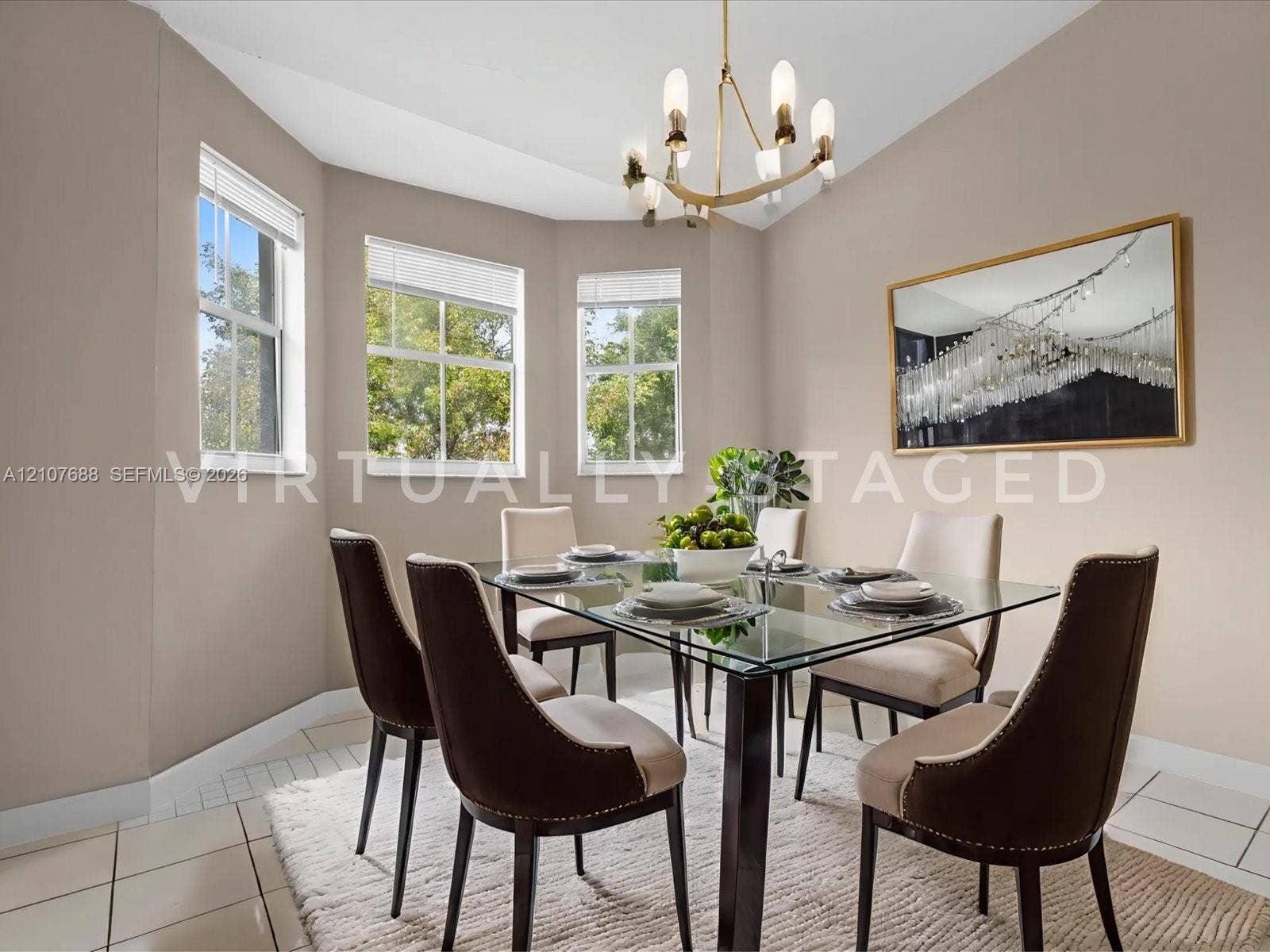 1677 SE 27th Court, #202, Homestead, FL 33035 Bay window featuring three large windows, neutral-toned walls, tile flooring, and an elevated metal chandelier with frosted glass shades