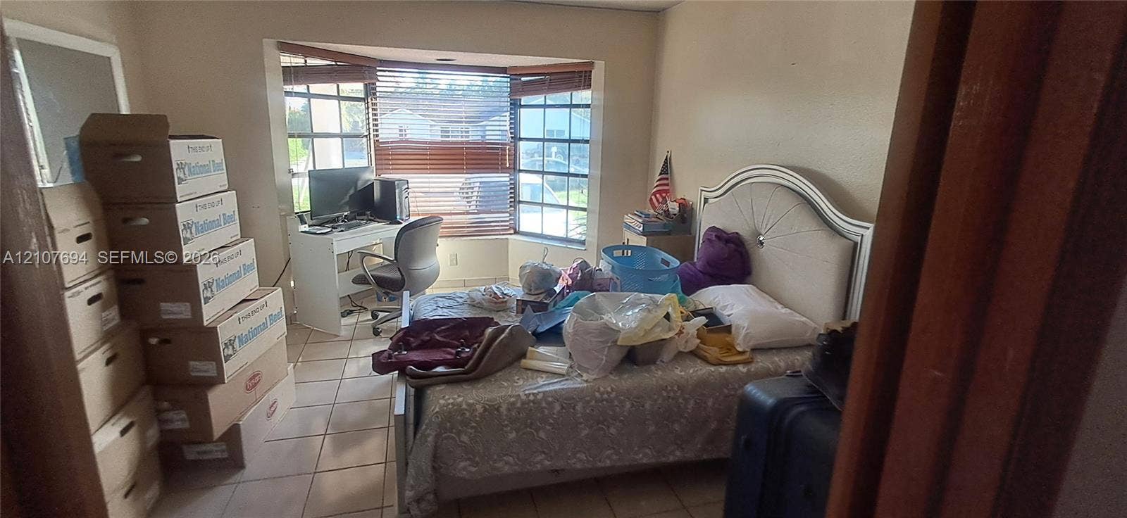 Room featuring tile flooring and a bay window configuration