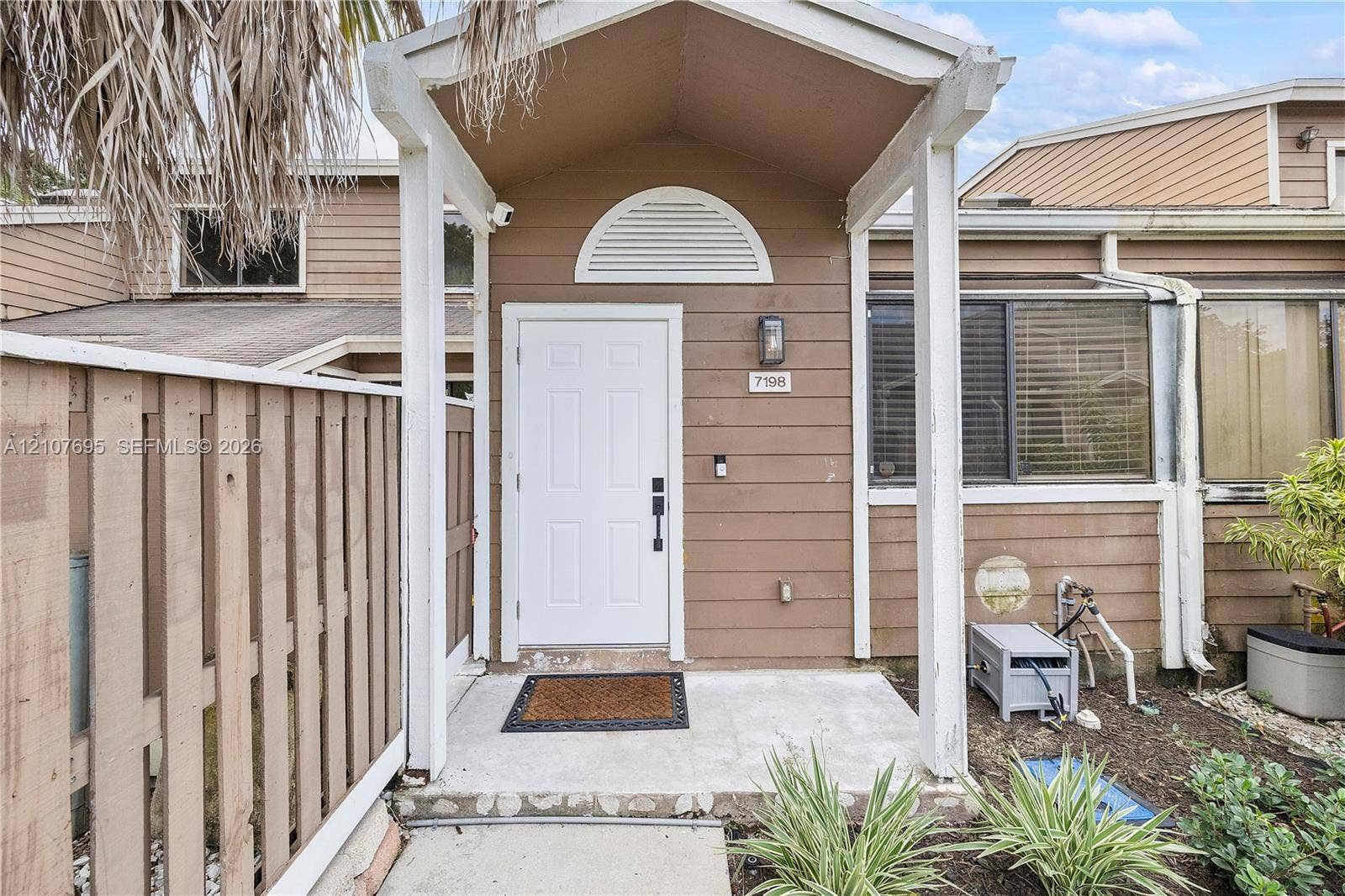 7198 Sportsmans Drive, North Lauderdale, FL 33068 Covered entryway with a white front door