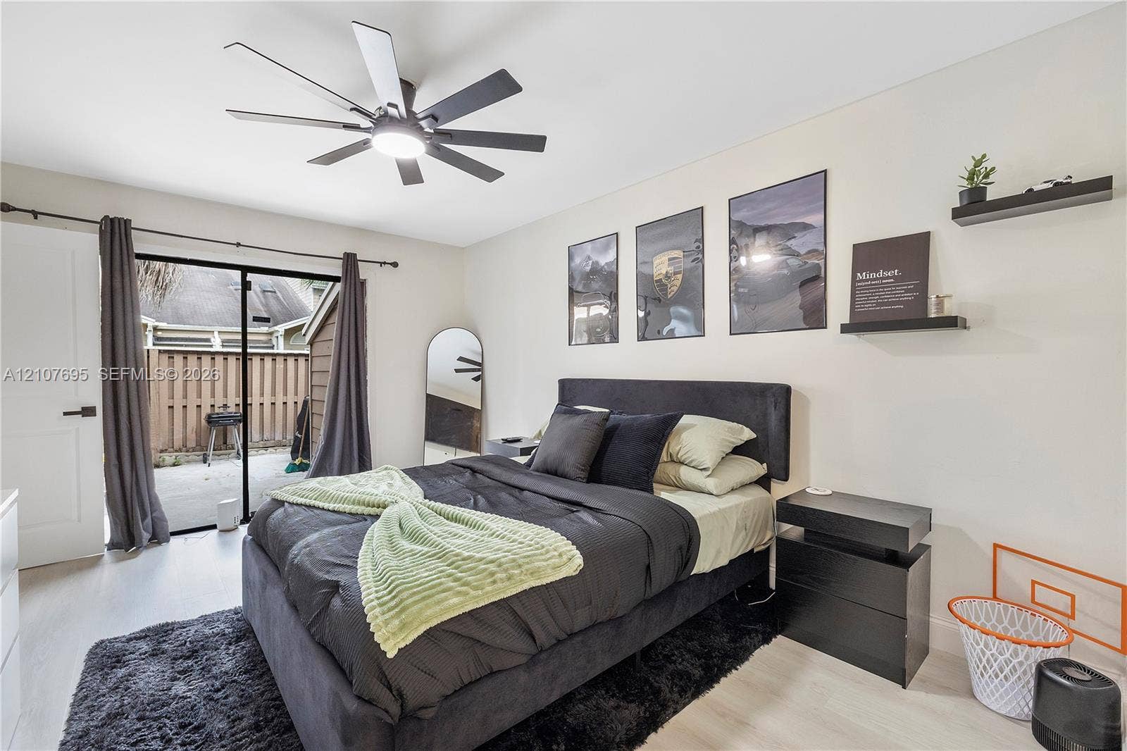 7198 Sportsmans Drive, North Lauderdale, FL 33068 Room featuring light-toned flooring, a multi-blade ceiling fan with integrated lighting, and a sliding glass door providing access to an enclosed patio area