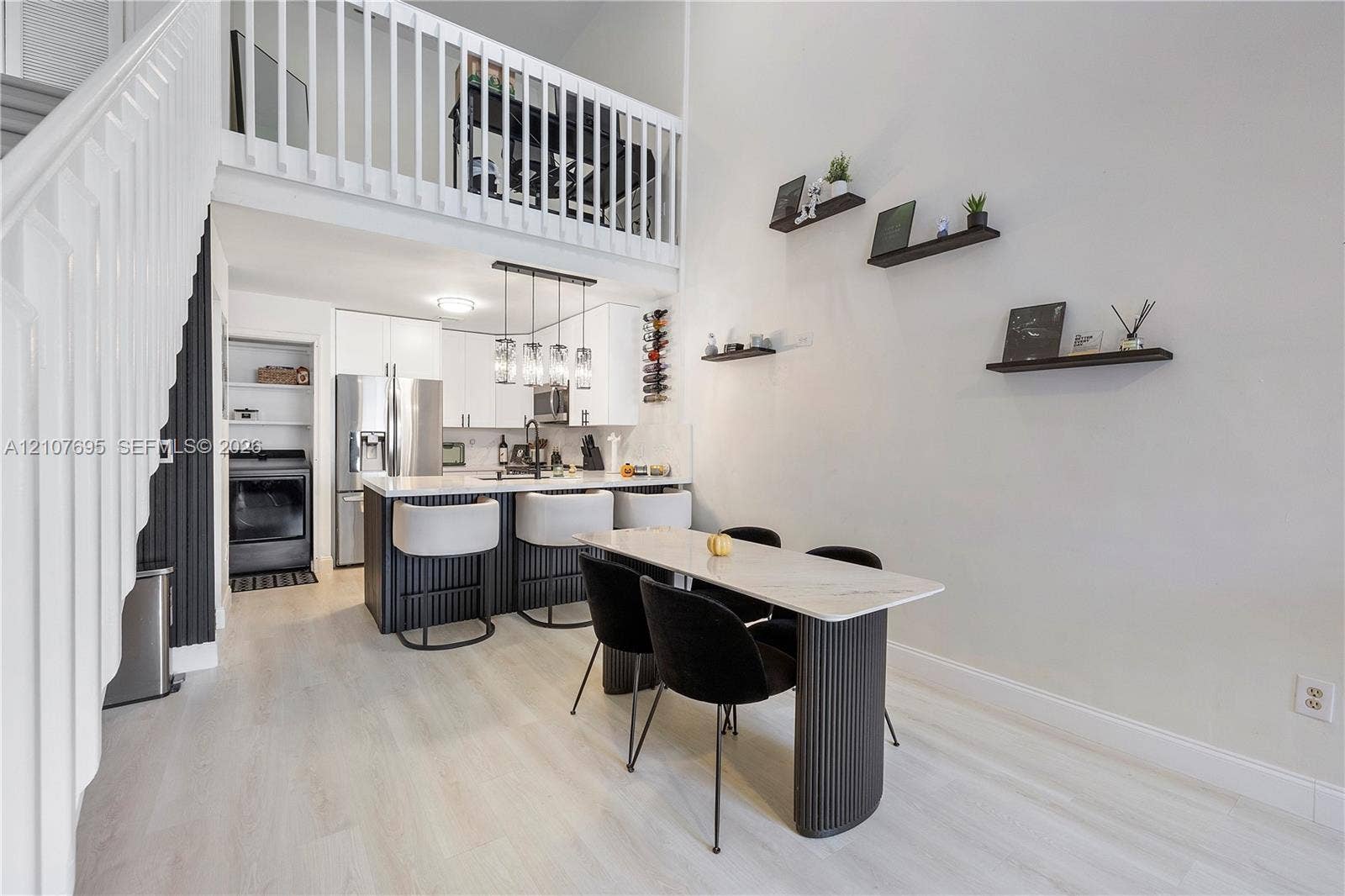7198 Sportsmans Drive, North Lauderdale, FL 33068 Double-height living area featuring a wood-finish staircase