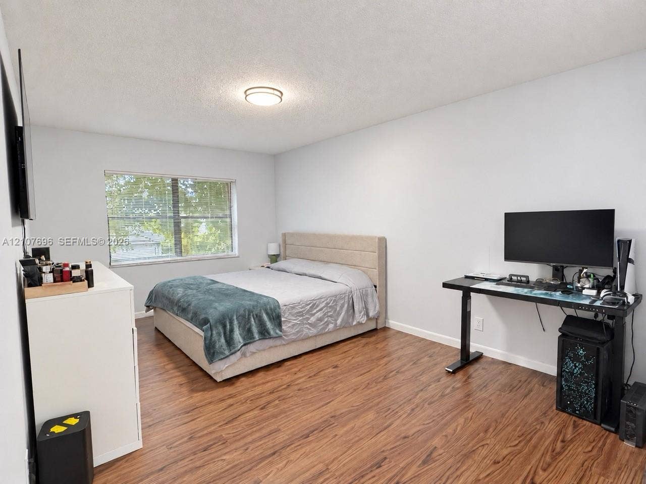 8290 Lake Drive, #418, Doral, FL 33166 Bedroom featuring wood-finish flooring, a neutral color palette, and a flush-mount ceiling light fixture