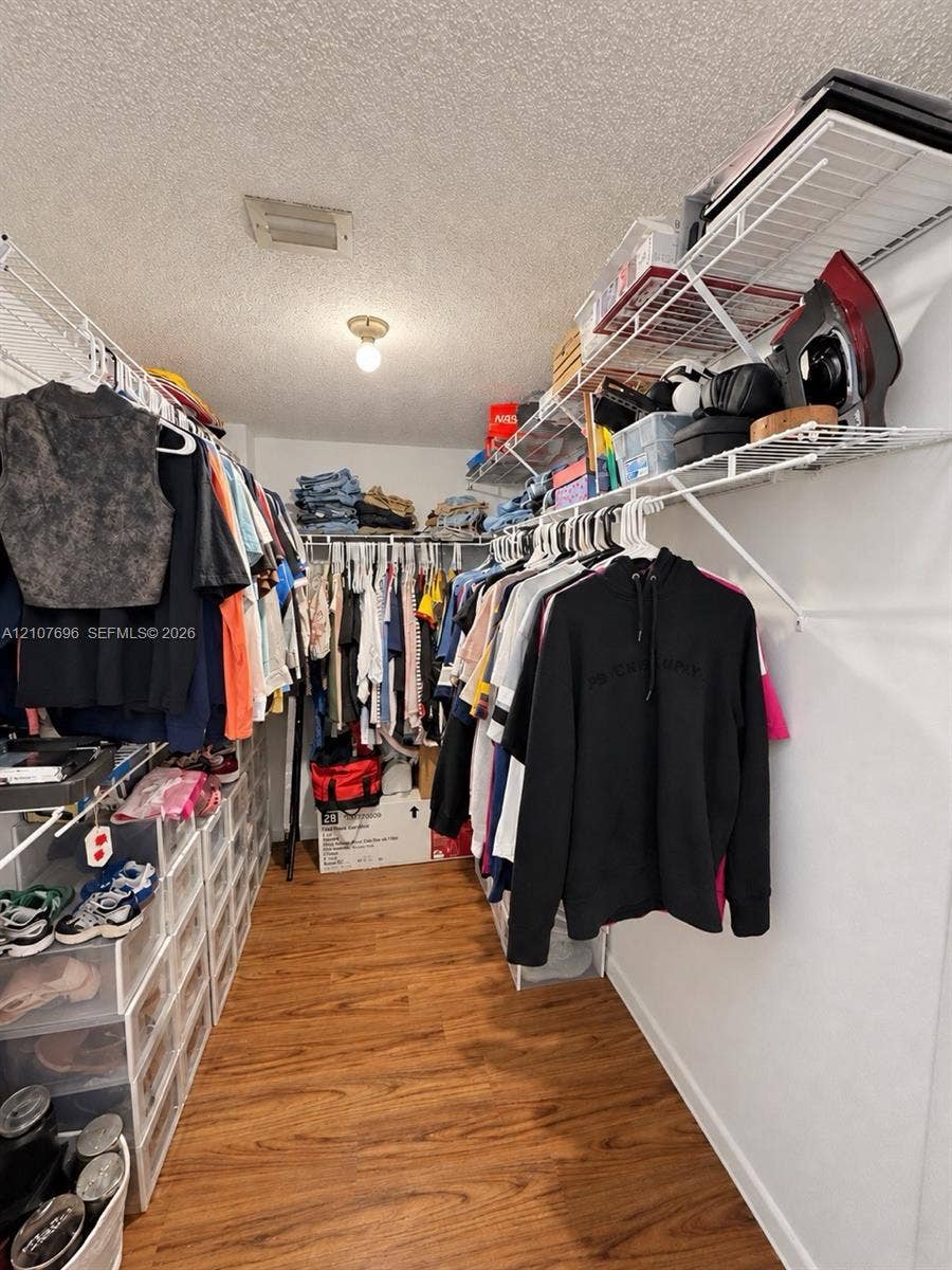 8290 Lake Drive, #418, Doral, FL 33166 Storage space featuring wood-finish flooring and tiered wire shelving