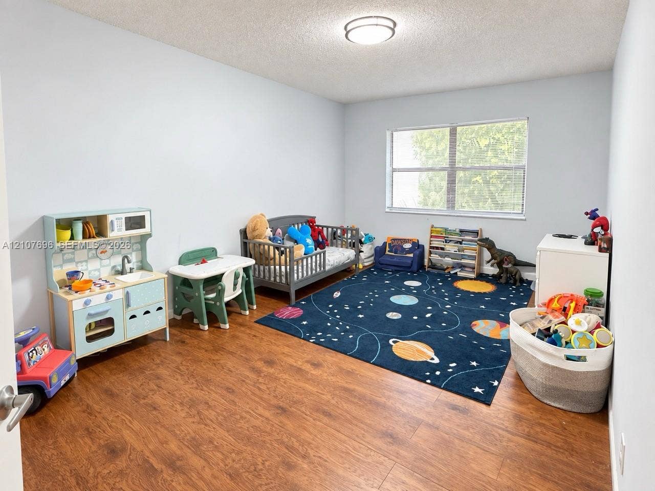 8290 Lake Drive, #418, Doral, FL 33166 Room featuring wood-finish flooring, a neutral paint palette, and a large window