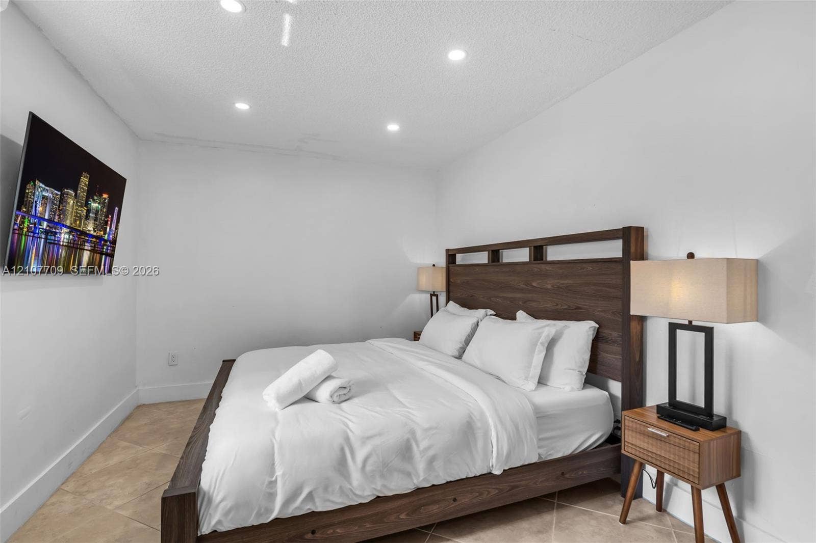Interior space featuring light-toned tile flooring, recessed ceiling lighting, and smooth-finish walls