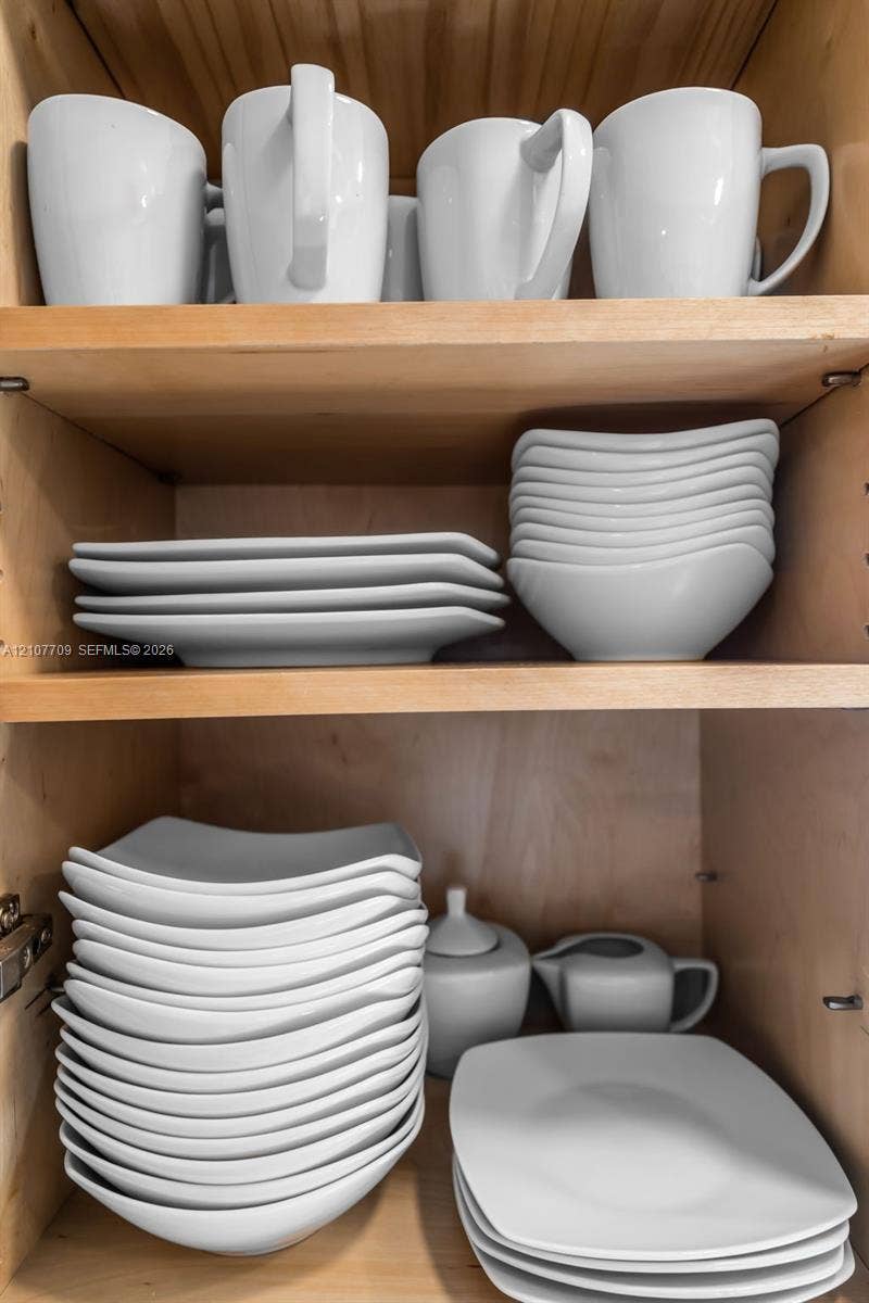 Natural wood-finish cabinetry featuring adjustable shelving and recessed metal hinge hardware