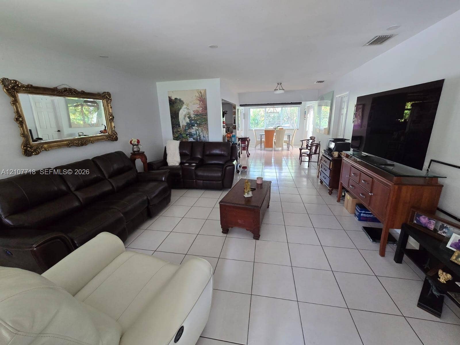 2321 N 57th Avenue, Hollywood, FL 33021 Open-concept interior featuring large-format ceramic tile flooring, recessed lighting, and expansive windows