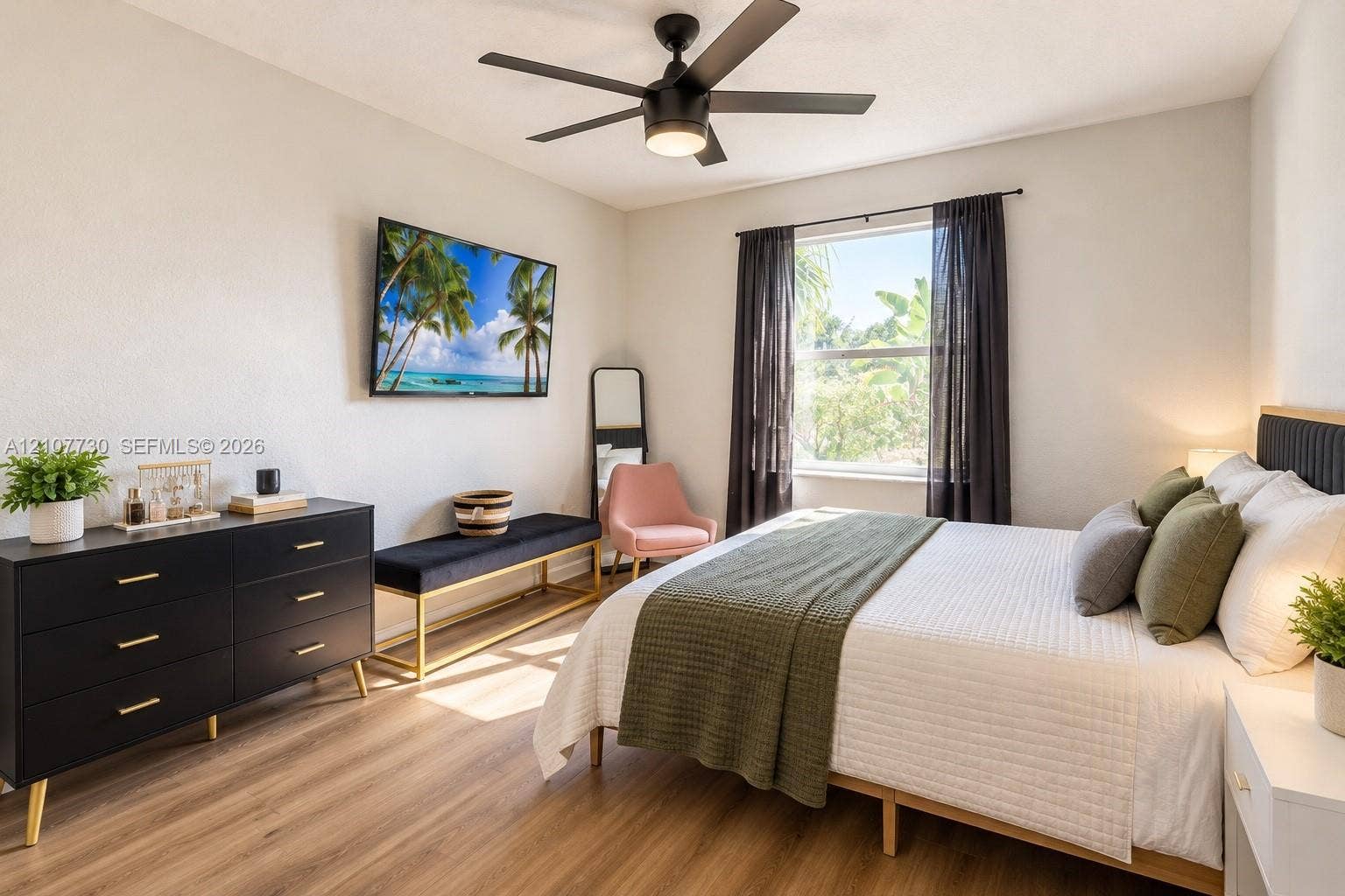 15606 SW 52nd Court, Miramar, FL 33027 Room featuring wood-finish flooring, a matte black multi-blade ceiling fan with integrated lighting, and a single-pane window