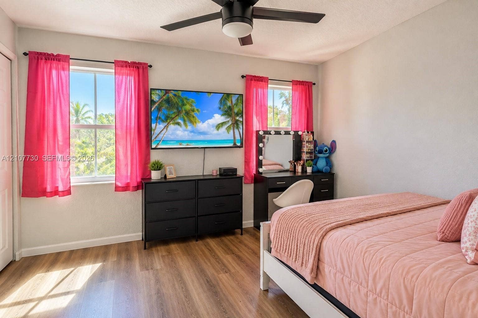 15606 SW 52nd Court, Miramar, FL 33027 Bedroom interior featuring wood-finish flooring, dual windows with natural light, and a matte black ceiling fan