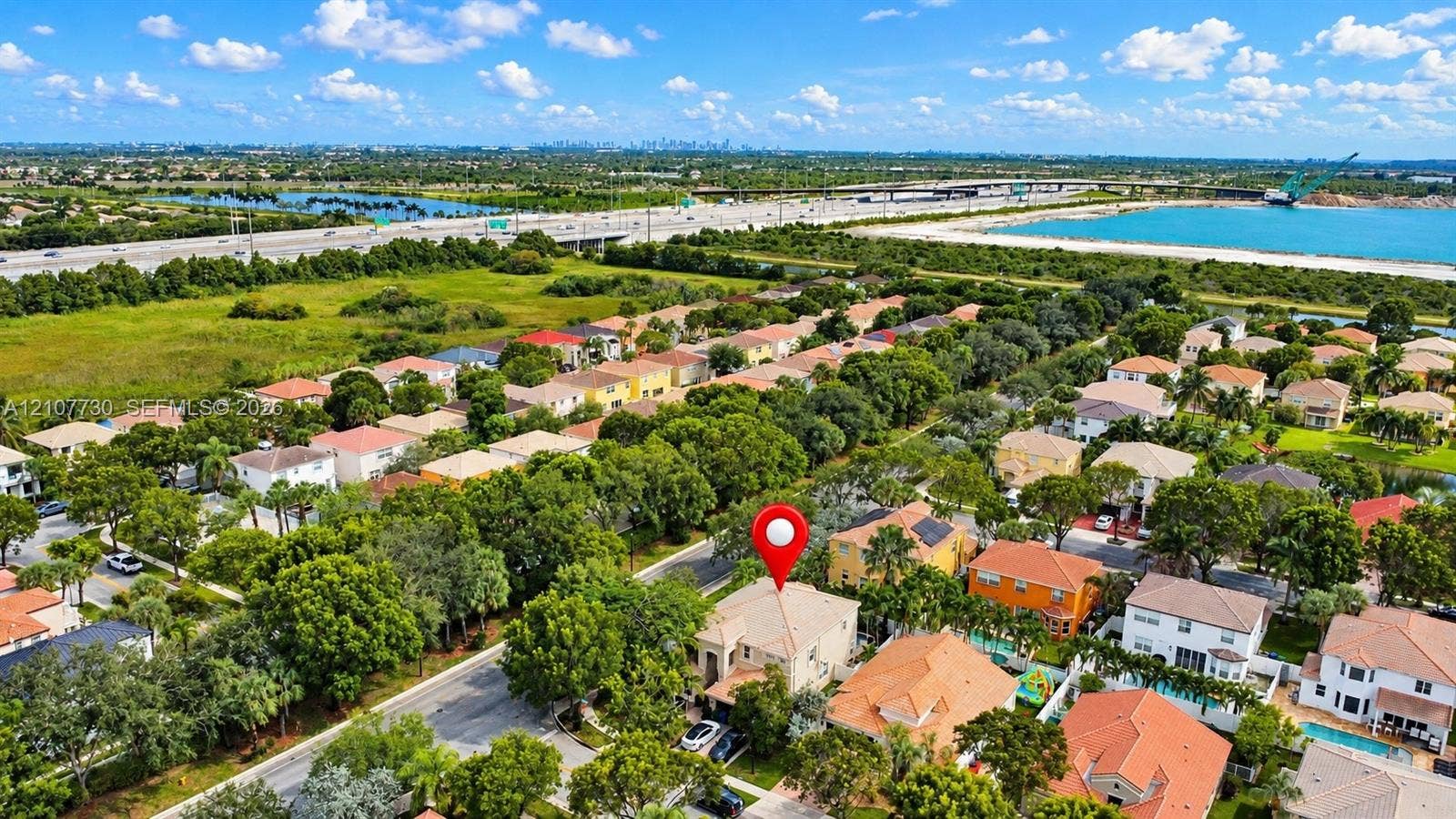 15606 SW 52nd Court, Miramar, FL 33027 Aerial perspective featuring a two-story residential structure with a hipped tile roof and paved driveway