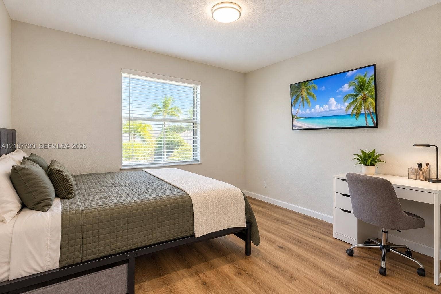 15606 SW 52nd Court, Miramar, FL 33027 Room featuring wood-finish flooring, a neutral color palette, a single-window configuration with horizontal blinds, and a mounted ceiling light fixture