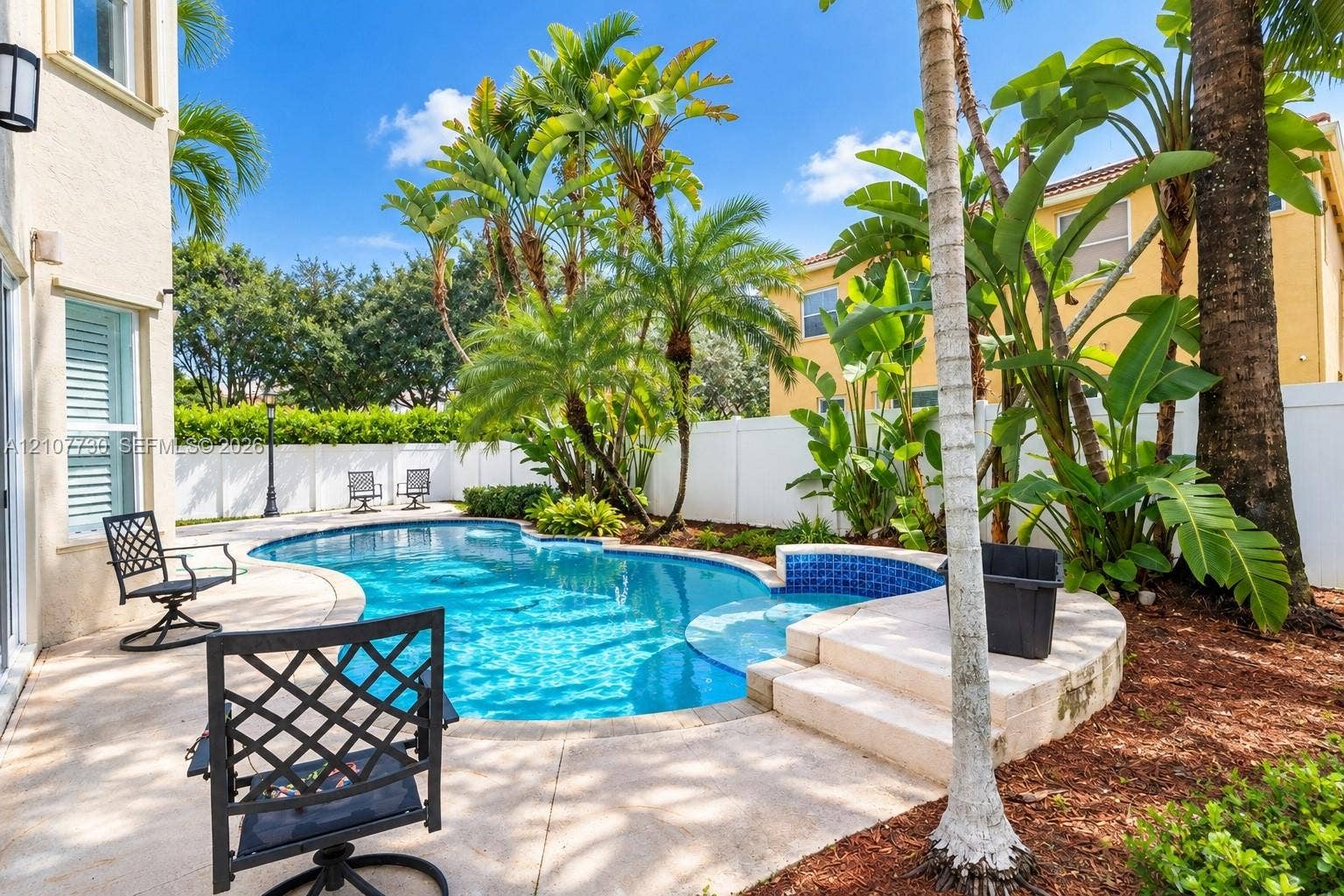 15606 SW 52nd Court, Miramar, FL 33027 Private outdoor space featuring a swimming pool, integrated spa, concrete patio, and perimeter privacy fencing