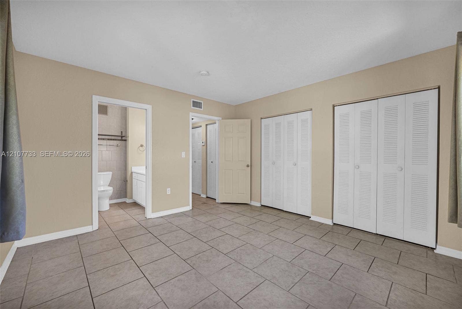 19606 SW 103rd Court, #4, Cutler Bay, FL 33157 Tile flooring throughout, dual closets with louvered doors, and a bathroom featuring a vanity cabinet