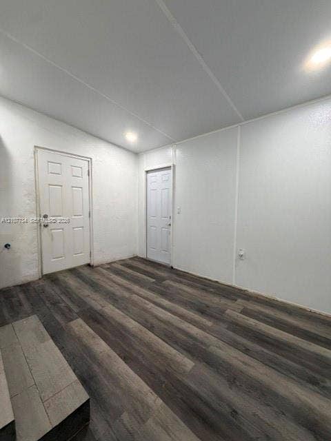 Interior space featuring wood-finish flooring, white walls, and recessed lighting