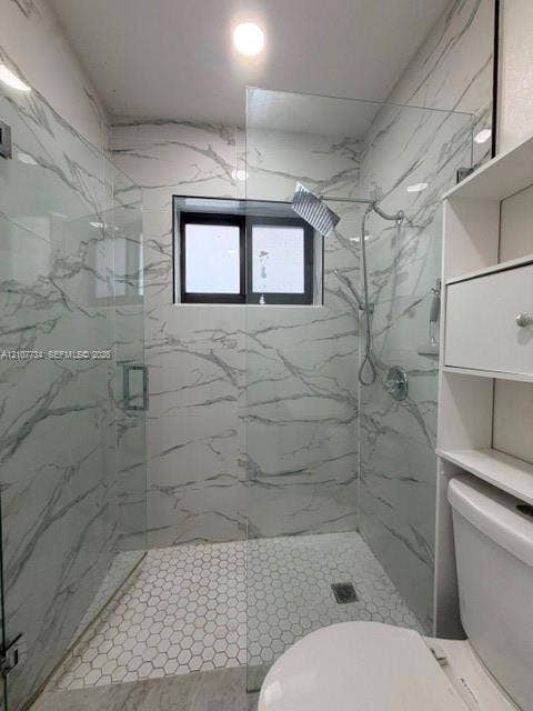 Walk-in shower featuring large-format patterned wall tile, hexagonal floor tile, a glass enclosure, and a modern rain-style shower head