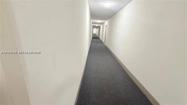 Hallway featuring neutral wall finishes, carpeted flooring, and recessed ceiling lighting