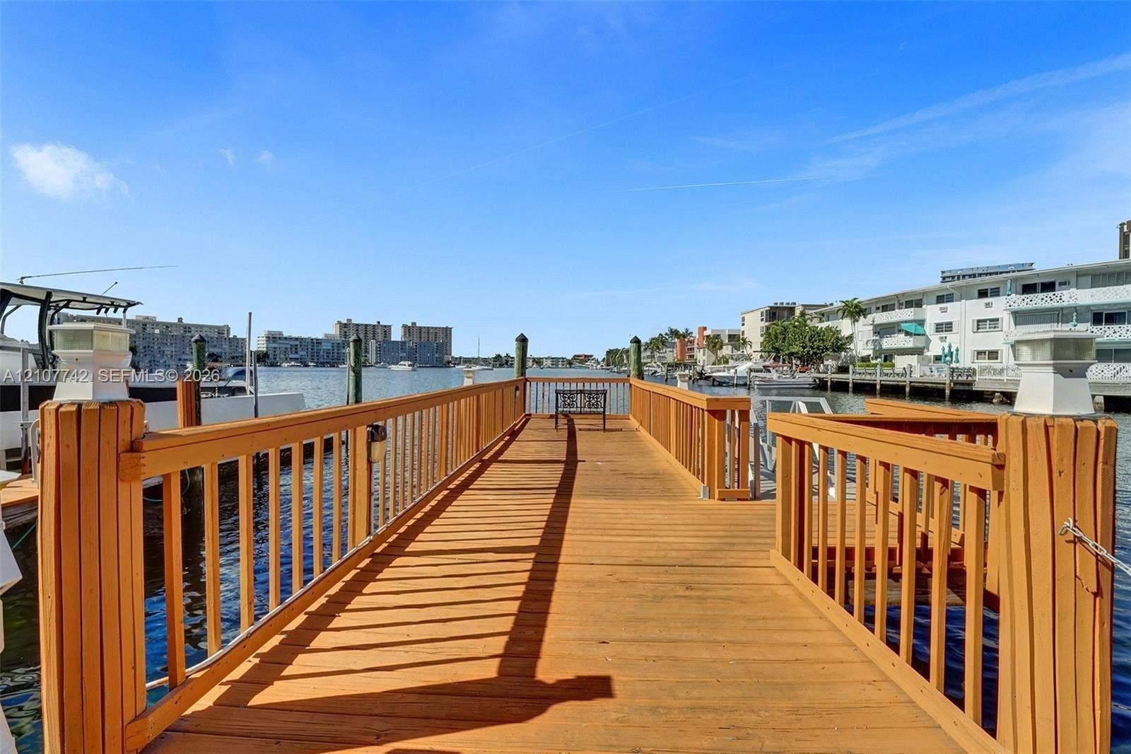 100 Golden Isles Drive, #112, Hallandale Beach, Hallandale Beach, FL 33009 Private wooden dock featuring vertical post railings and integrated lighting