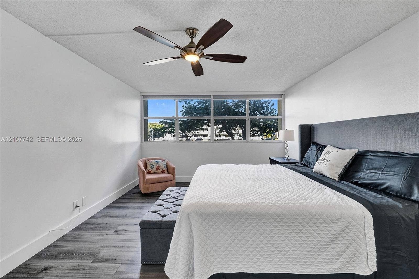100 Golden Isles Drive, #112, Hallandale Beach, Hallandale Beach, FL 33009 Wood-finish flooring, multi-pane picture windows, and a ceiling fan with integrated lighting
