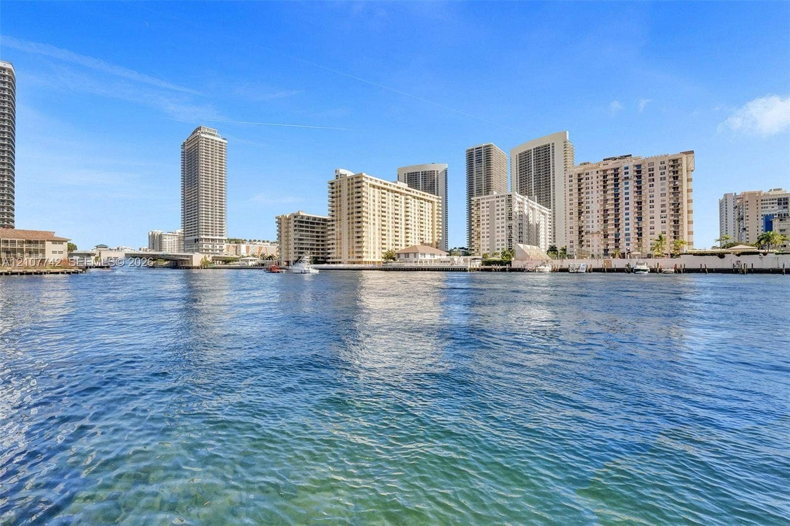 100 Golden Isles Drive, #112, Hallandale Beach, Hallandale Beach, FL 33009 Waterfront location featuring direct access to the waterway, a bulkhead along the shoreline, and proximity to high-rise structures