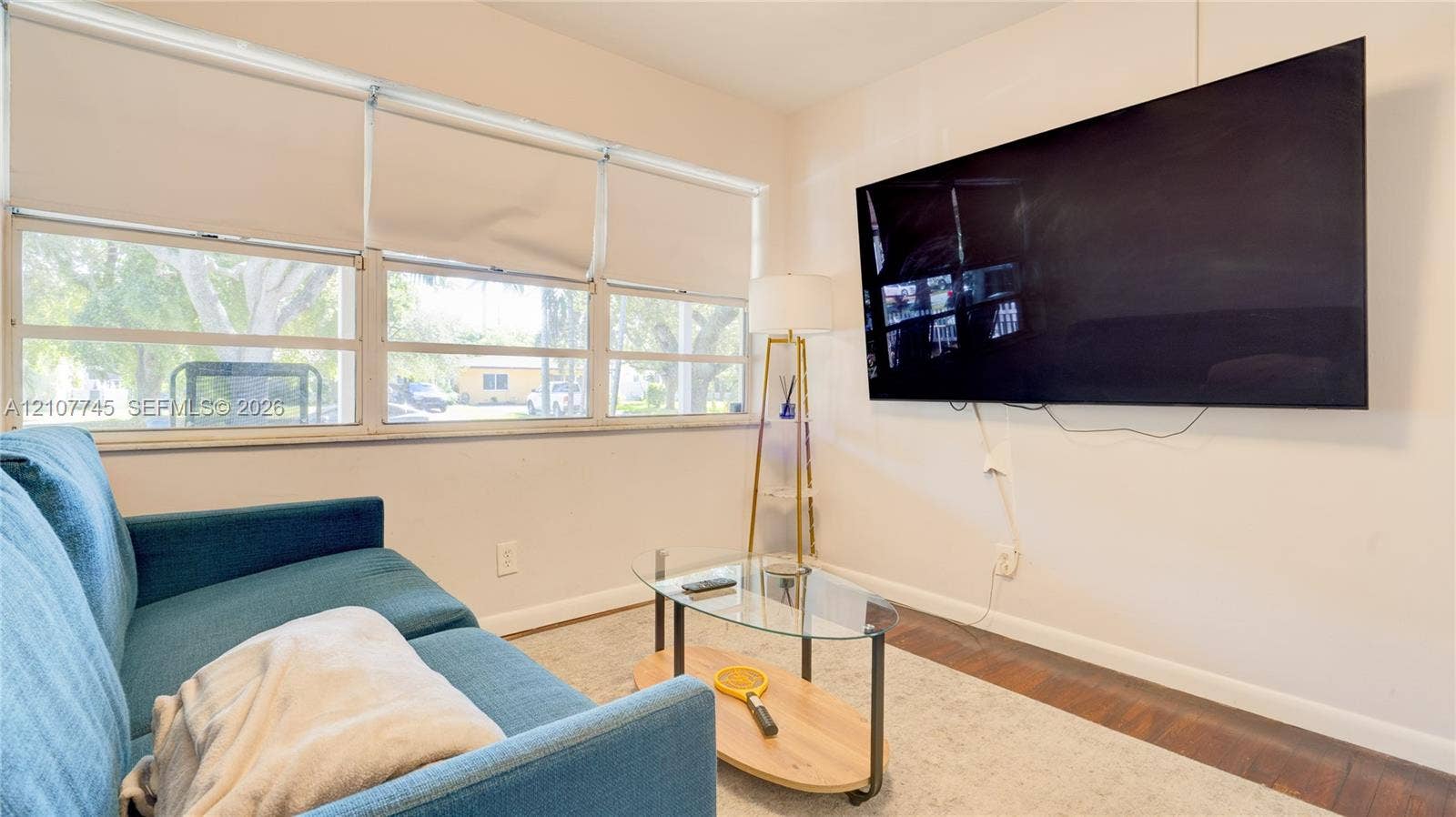 Multi-pane windows with integrated blinds and wood-finish flooring