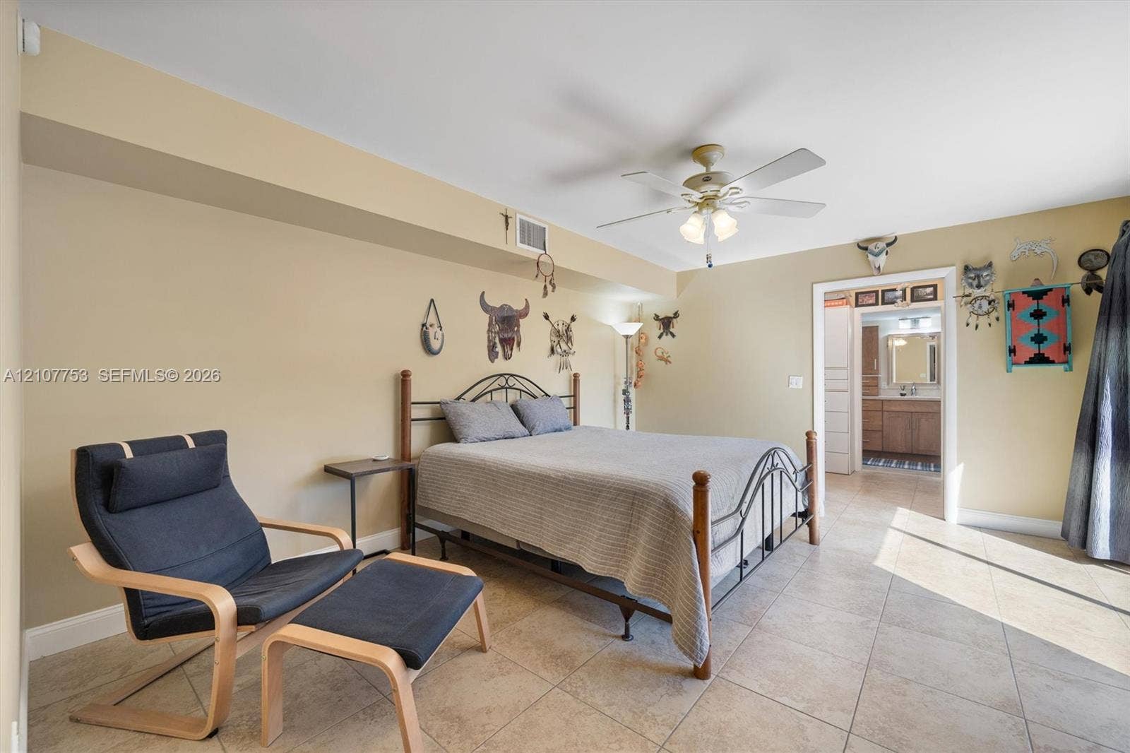 Neutral-toned room featuring large-format tile flooring, recessed ceiling lighting, and a central ceiling fan