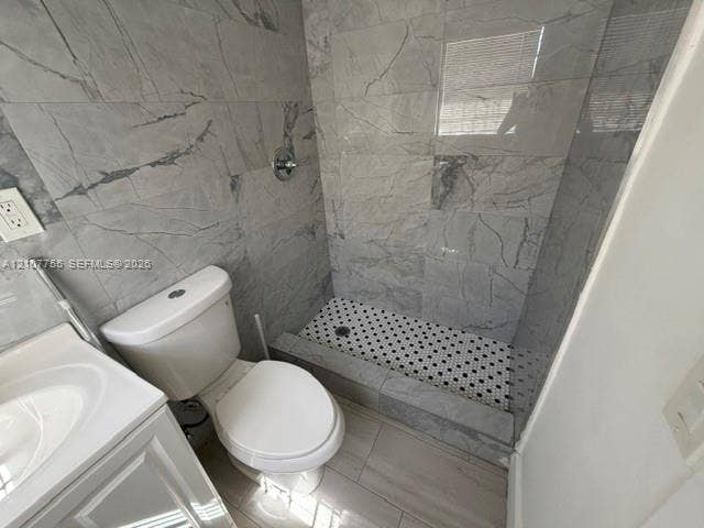 930 SW 29th Street, #A-C, Fort Lauderdale, Fort Lauderdale, FL 33315 Walk-in shower with floor-to-ceiling large-format tile surround, hex-pattern mosaic floor, white vanity, and chrome fixtures
