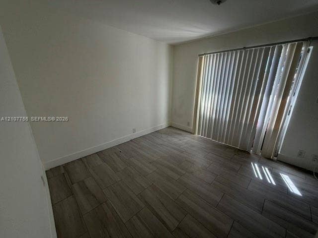 930 SW 29th Street, #A-C, Fort Lauderdale, Fort Lauderdale, FL 33315 Interior room featuring wood-finish flooring and sliding glass doors with vertical blinds