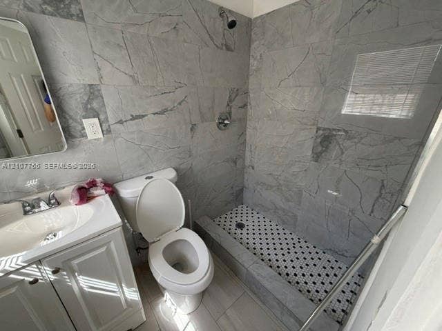 930 SW 29th Street, #A-C, Fort Lauderdale, Fort Lauderdale, FL 33315 Full-height gray stone-finish wall tiling, walk-in shower with mosaic tile flooring, white vanity with integrated sink, and polished chrome fixtures