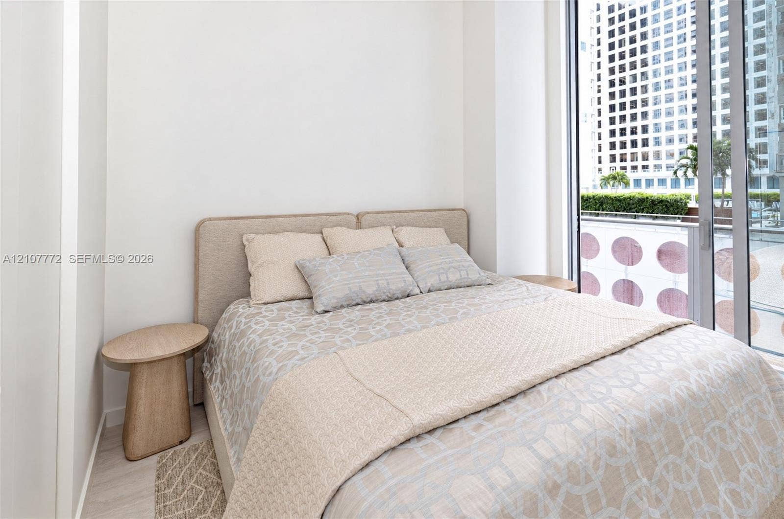 77 SE 5th Street, #1210, Miami, Miami, FL 33131 Floor-to-ceiling sliding glass door, neutral interior walls, and light-toned wood-finish flooring