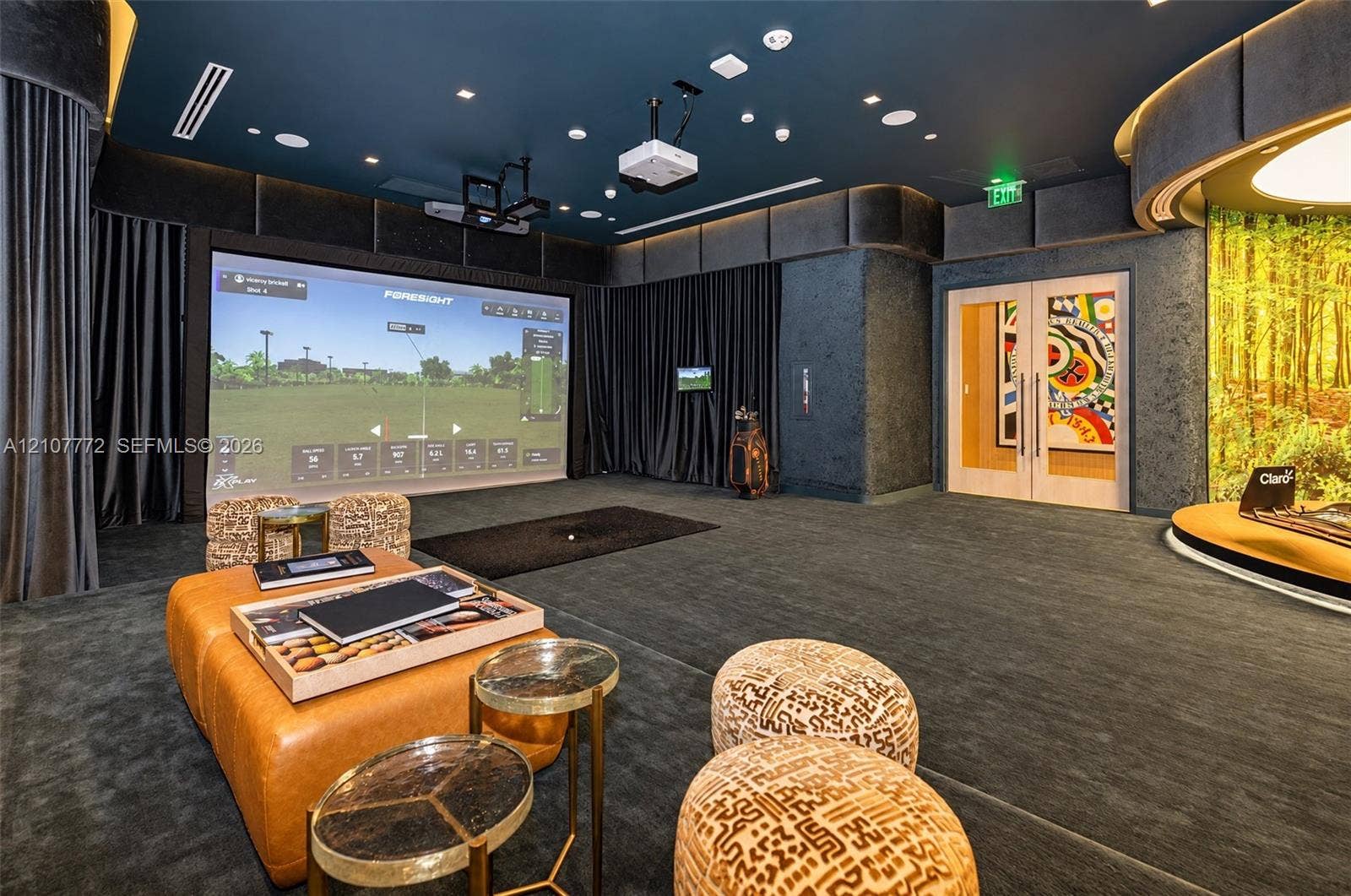 77 SE 5th Street, #1210, Miami, Miami, FL 33131 Dedicated recreation room featuring a built-in golf simulator, integrated projection system, recessed cove lighting, and floor-to-ceiling drapery