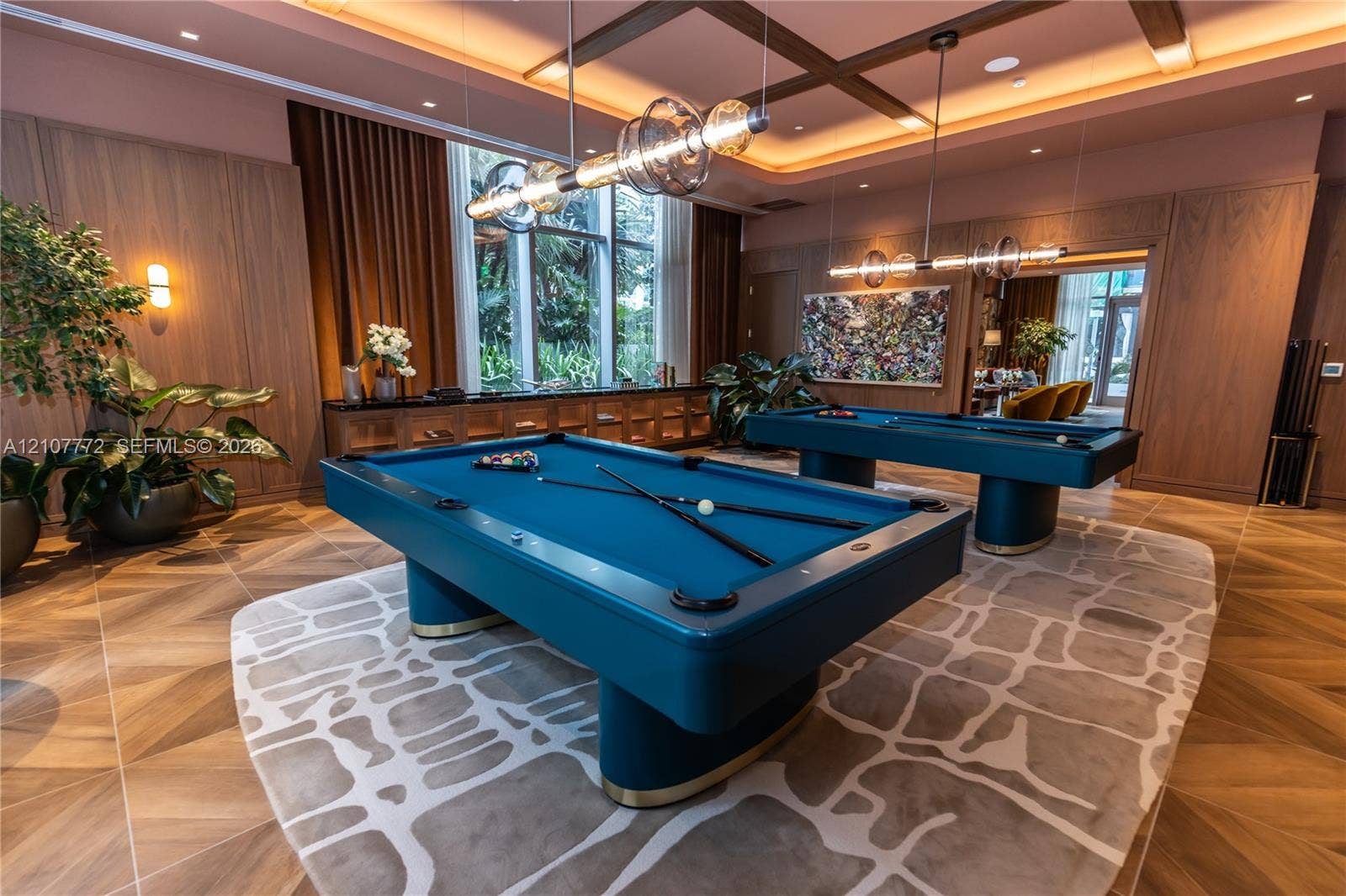 77 SE 5th Street, #1210, Miami, Miami, FL 33131 Wood-finish flooring, coffered ceiling with recessed lighting, floor-to-ceiling wood wall paneling, built-in cabinetry, and multi-light linear pendant fixtures