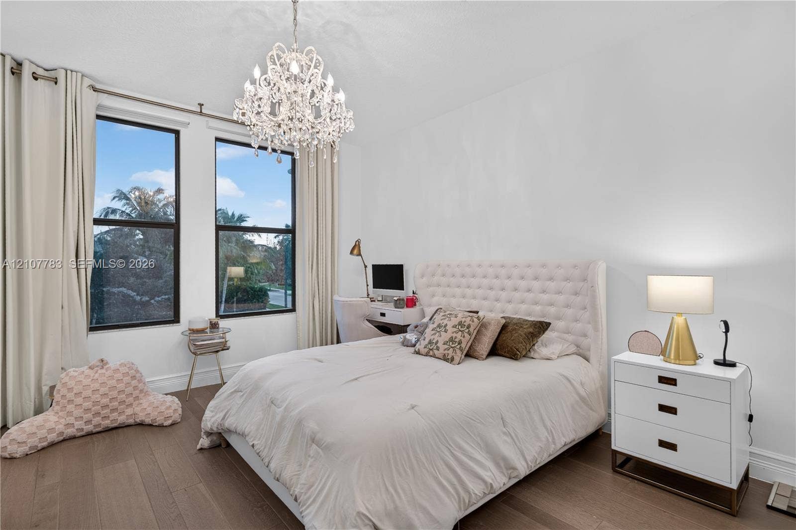 9328 Tropez Lane, Delray Beach, FL 33446 Room with wood-finish flooring, dual windows with dark frames, and a decorative crystal chandelier