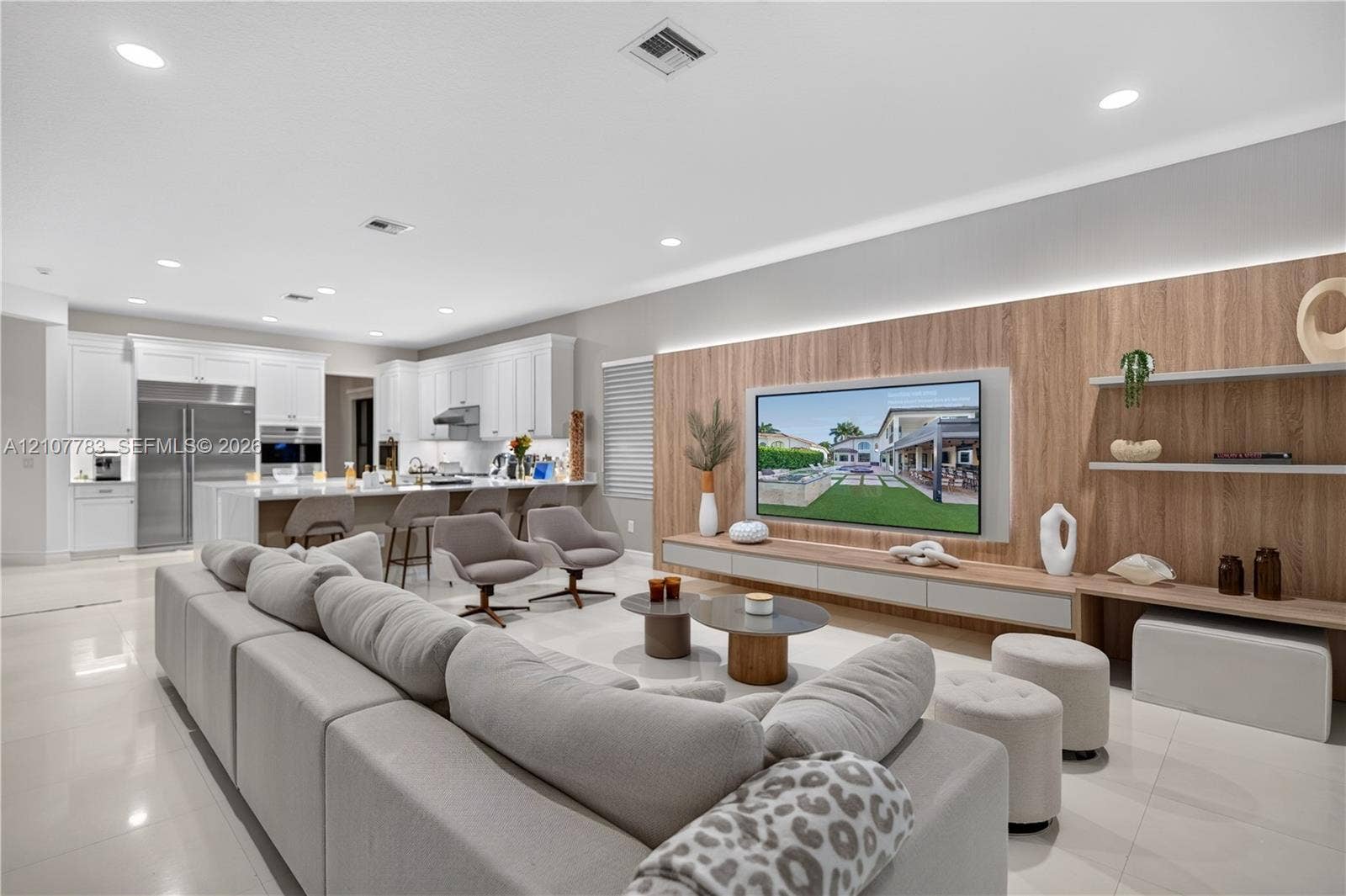9328 Tropez Lane, Delray Beach, FL 33446 Open-concept area featuring polished tile flooring, recessed lighting, and a kitchen with white cabinetry and stainless steel appliances