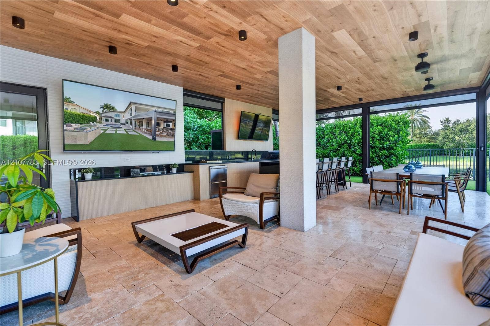 9328 Tropez Lane, Delray Beach, FL 33446 Covered outdoor living space featuring natural stone flooring, wood-plank ceiling, recessed lighting, and a built-in outdoor kitchen with stone countertop
