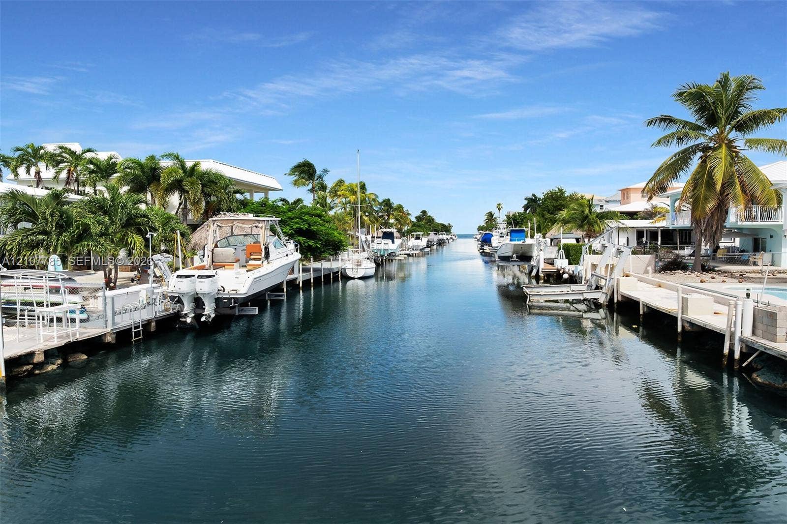 Waterfront canal featuring private boat docks and bulkhead seawalls