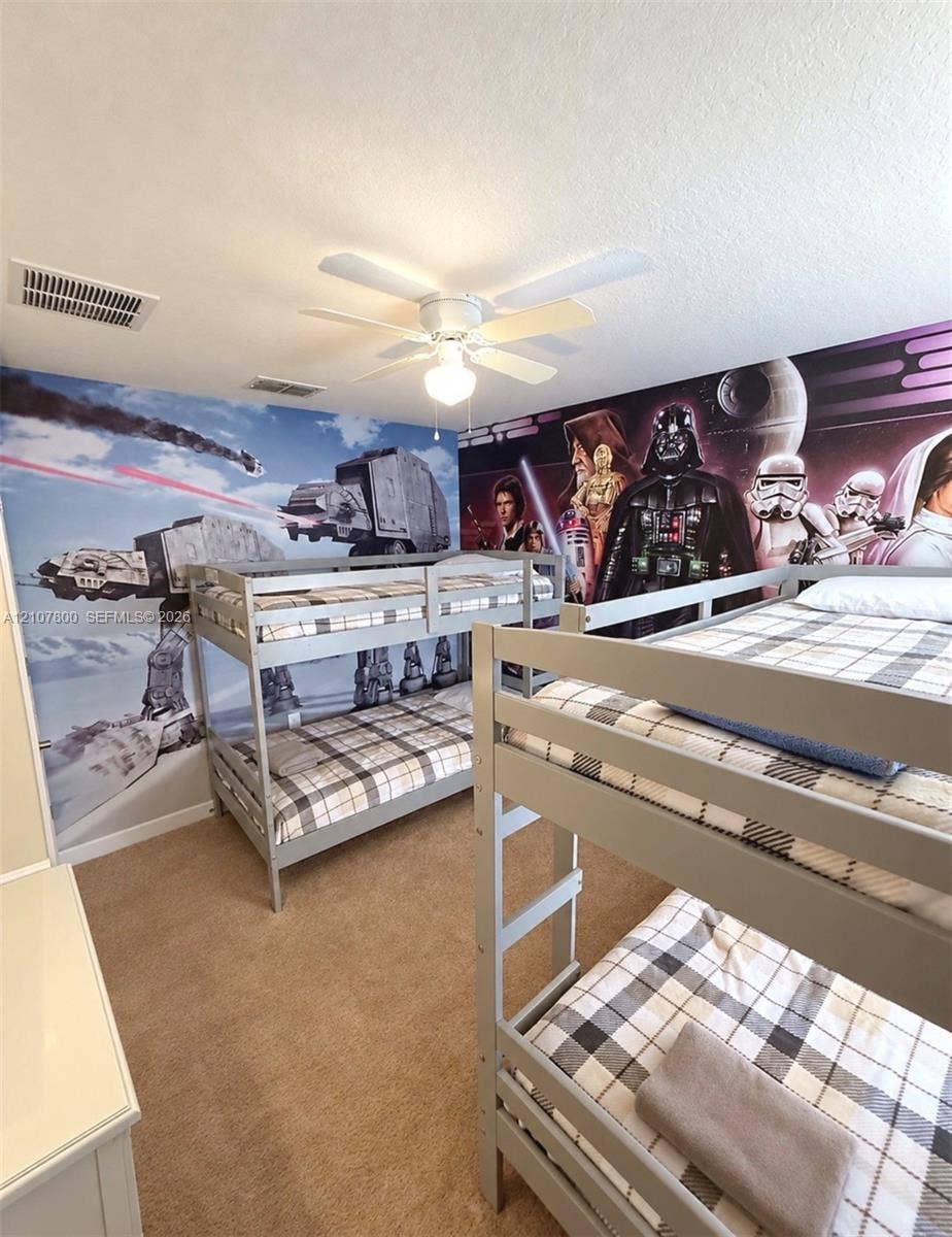 1476 Moon Valley, Davenport, FL 33896 Room featuring wall-to-wall printed murals, neutral carpeting, and a central ceiling fan with integrated lighting fixture