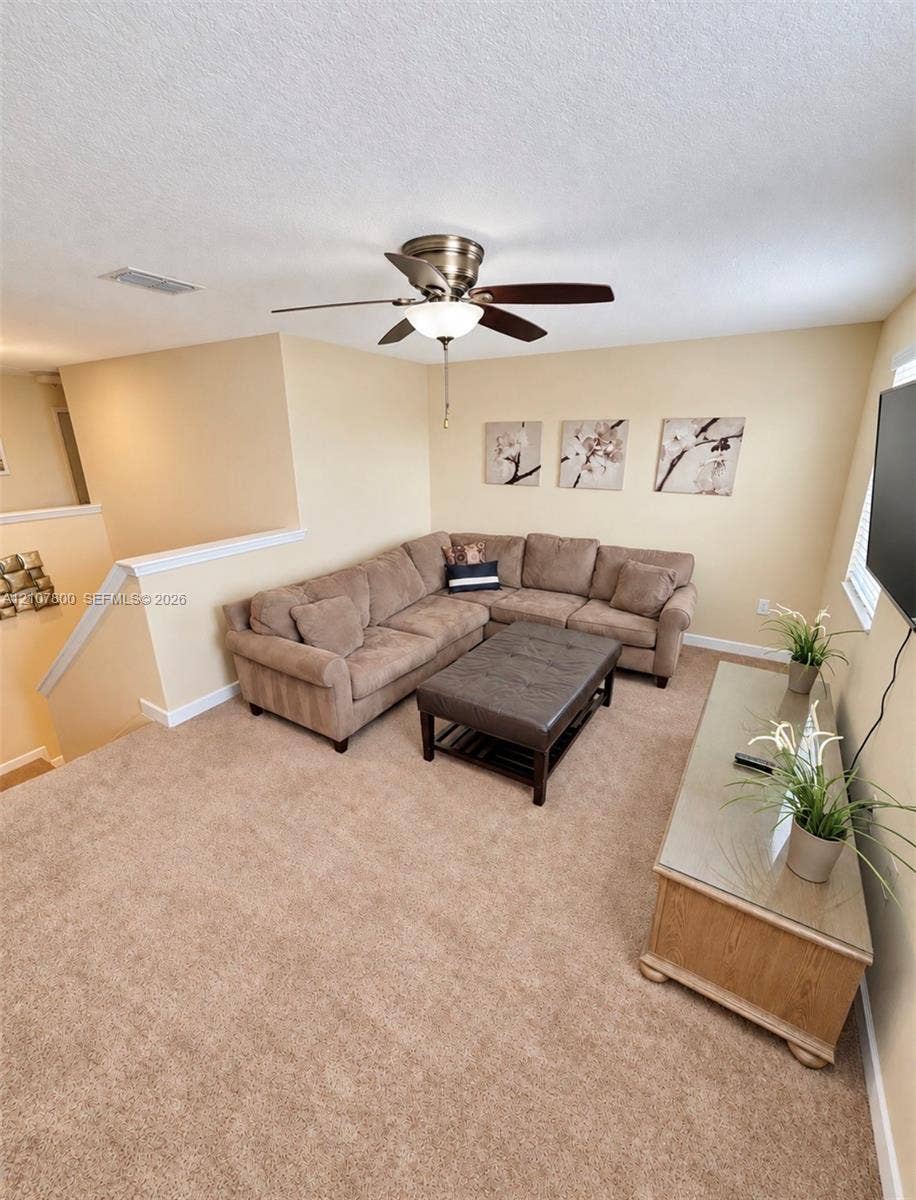1476 Moon Valley, Davenport, FL 33896 Neutral-toned carpeting and overhead ceiling fan with integrated light fixture