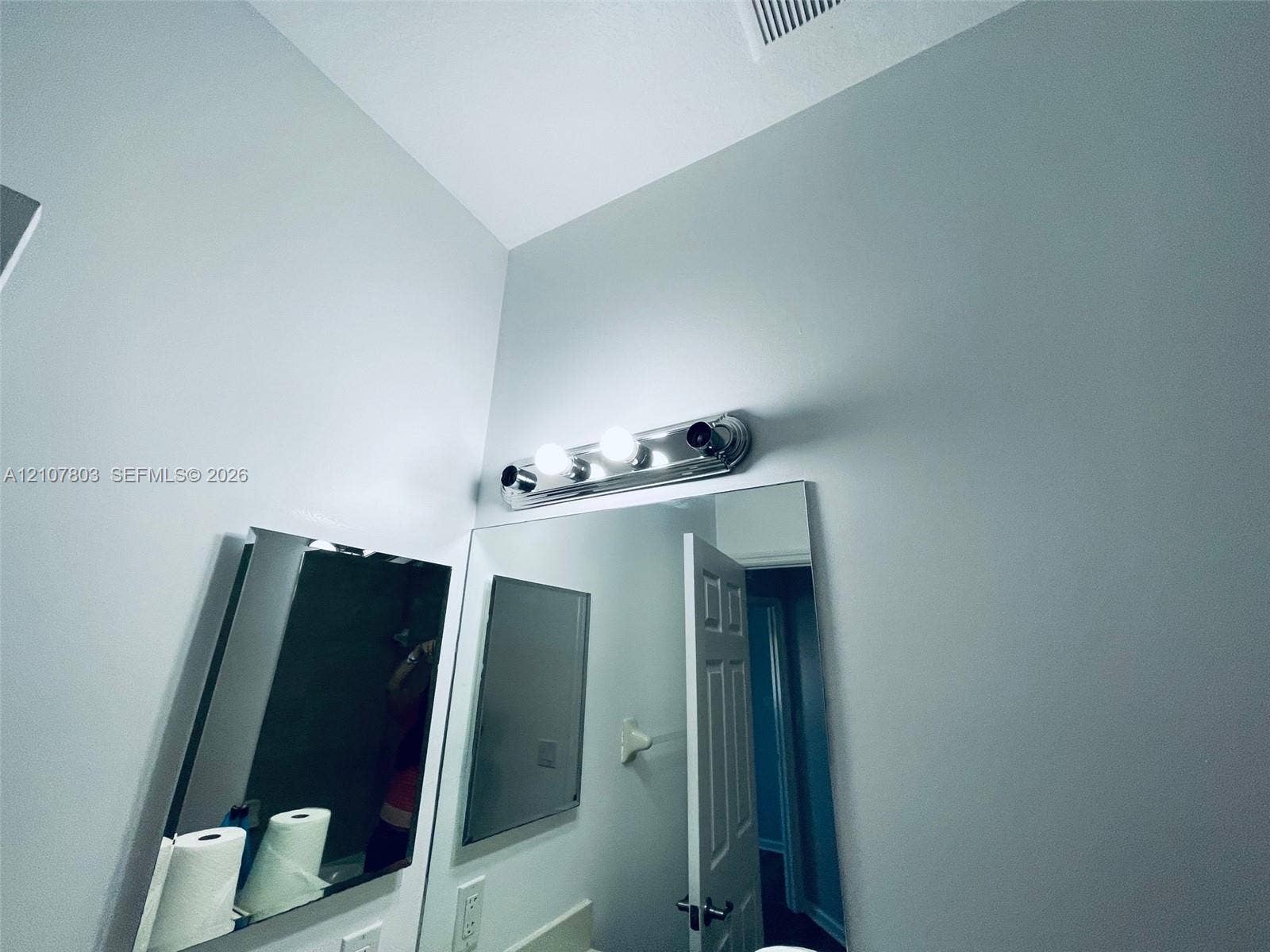 8620 NW 97th Avenue, #205, Doral, FL 33178 Large frameless mirror accented by a three-light polished chrome vanity fixture