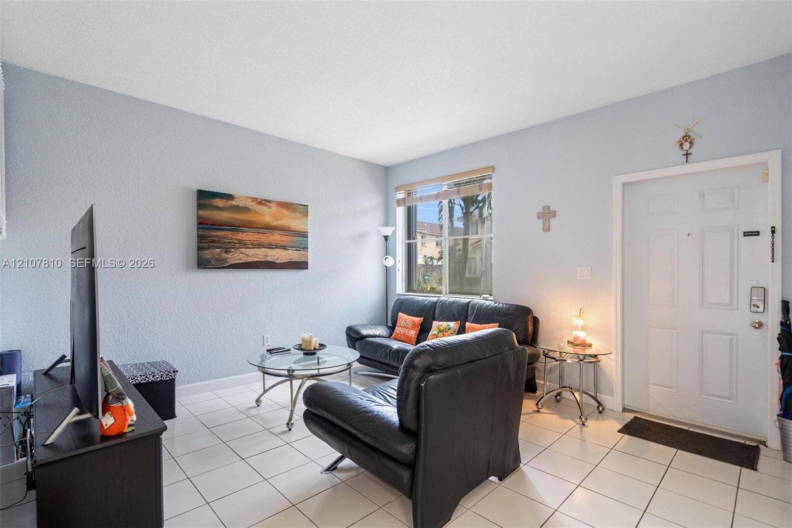 6940 NW 177th Street, #P105, Hialeah, Hialeah, FL 33015 Living area featuring white ceramic tile flooring, neutral wall tones, and a window with horizontal blinds