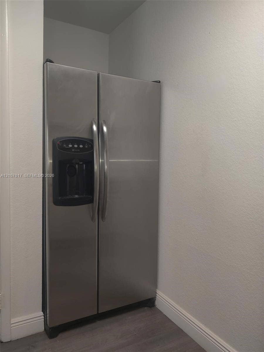 1705 Palm Cove Boulevard, #1-104, Delray Beach, Delray Beach, FL 33445 Stainless steel side-by-side refrigerator featuring an integrated water and ice dispenser