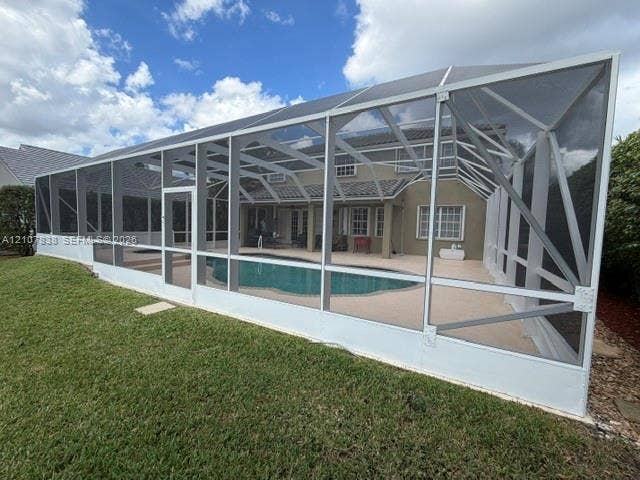 133 Cameron Drive, Weston, FL 33326 Screen-enclosed patio featuring a swimming pool, concrete pool deck, and integrated spa
