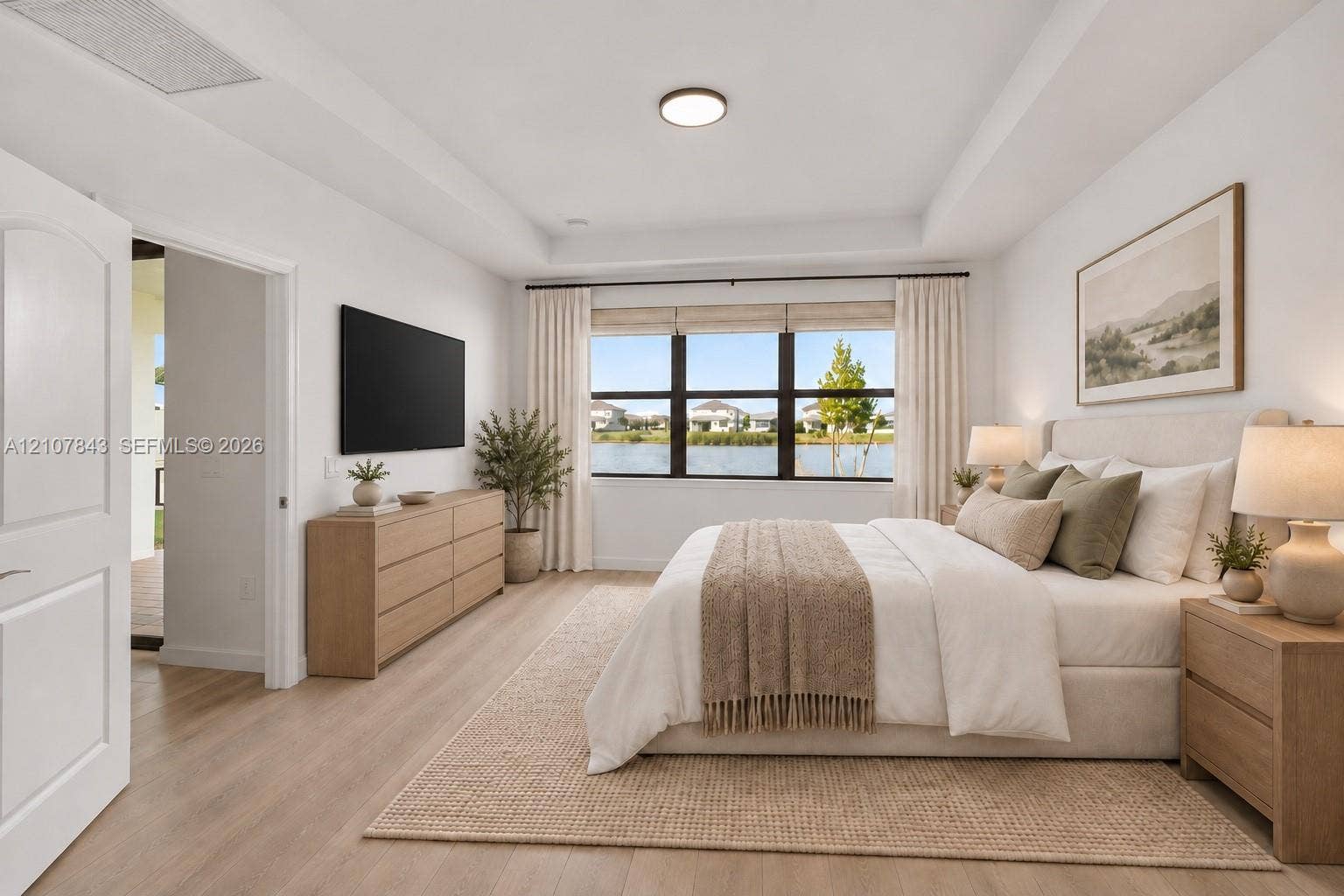 4949 Blistering Way, Lake Worth, FL 33467 Tray ceiling with flush-mount lighting, expansive windows, wood-finish flooring, and crisp white wall finishes